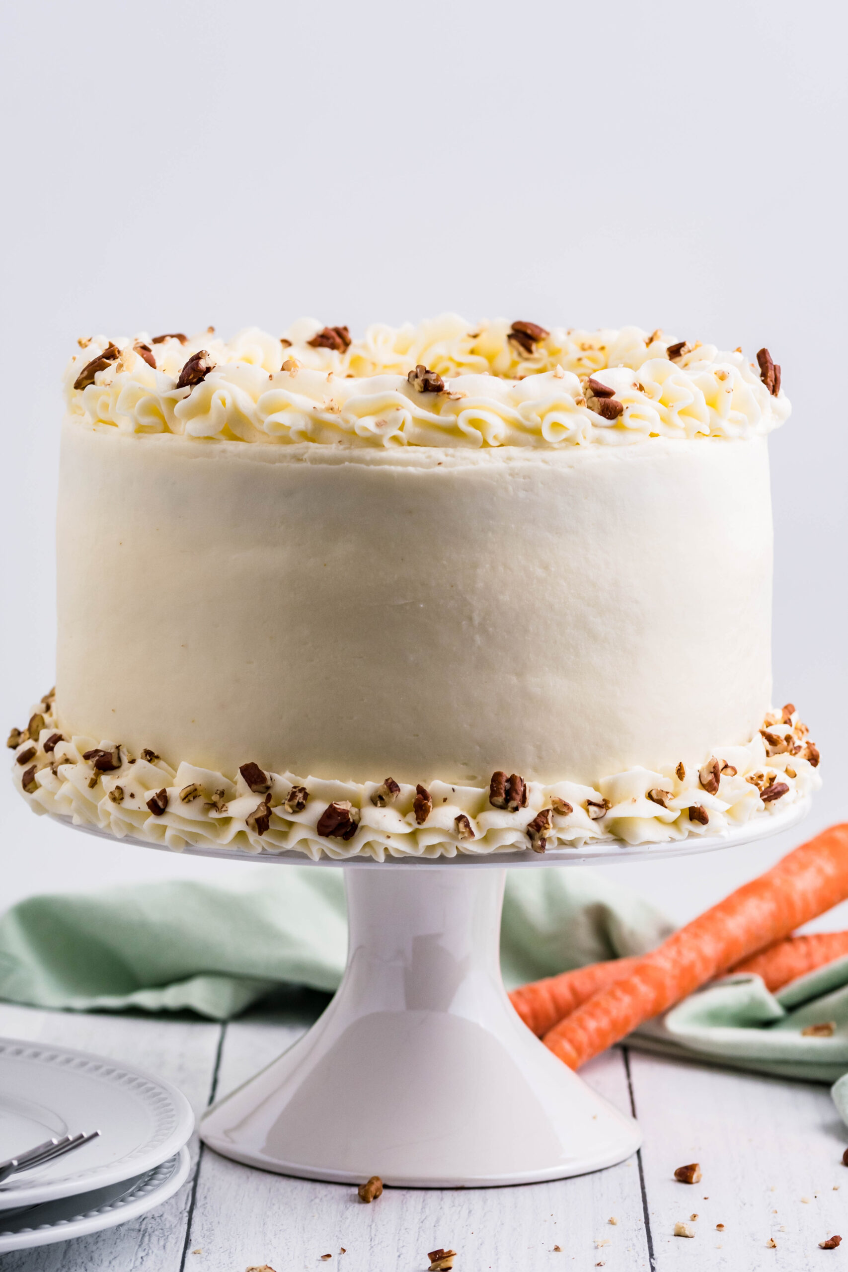 Front view of Carrot Cake on a white cake stand.