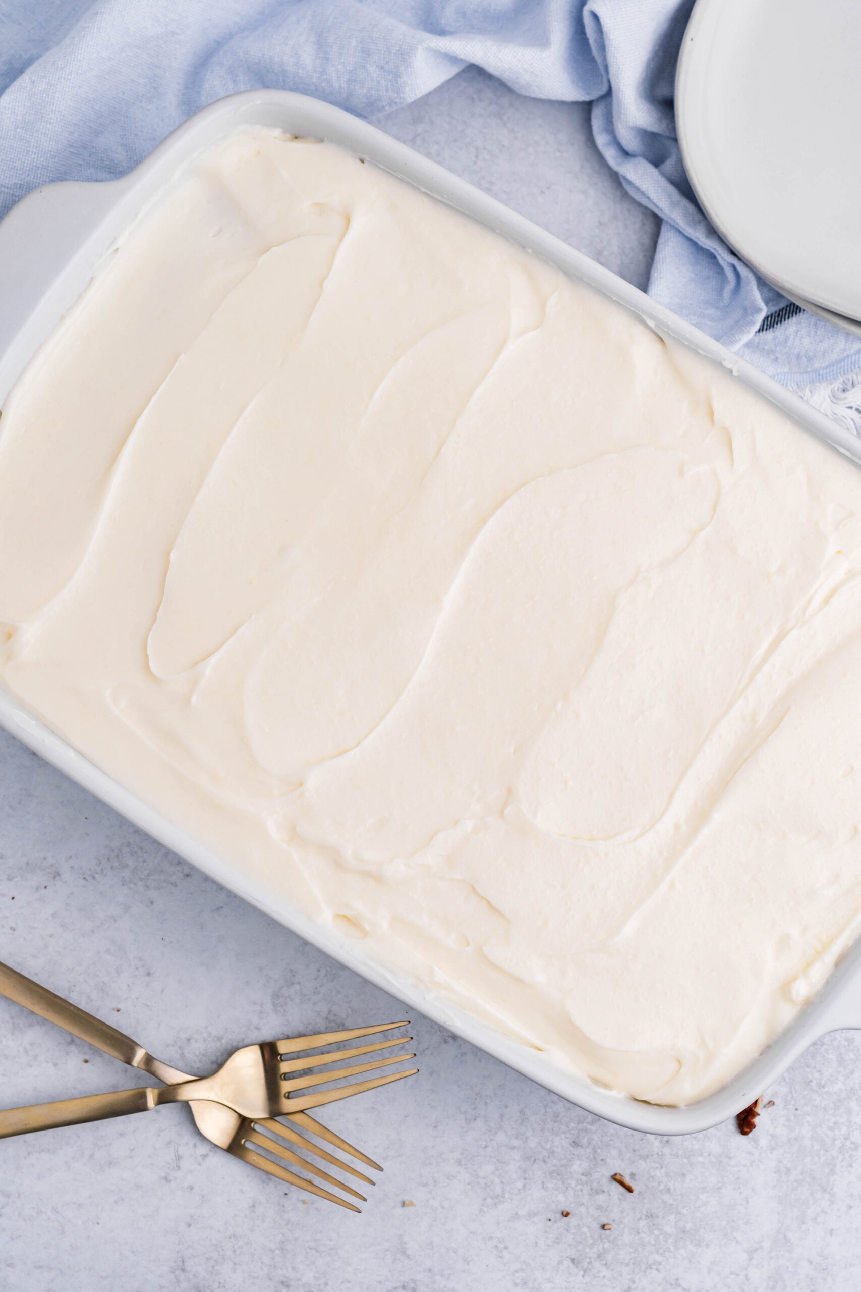 Overhead view of Banana Sheet Cake in a white baking dish.