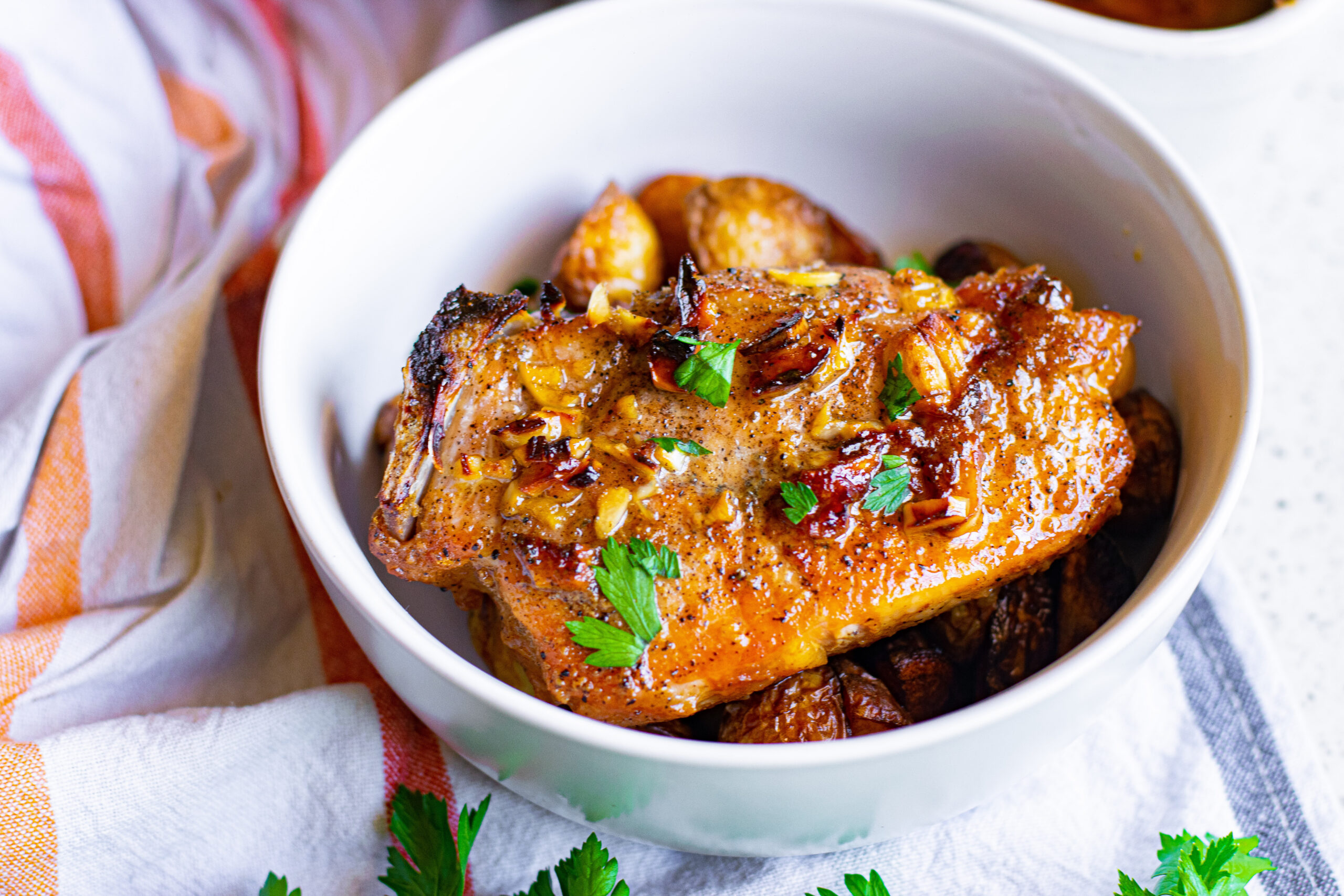 Overhead view of Honey Garlic Pork Chops served over potatoes.