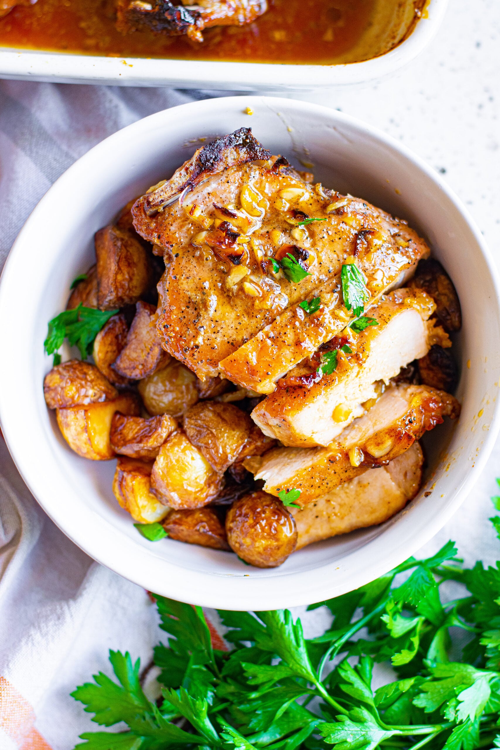 Overhead view of Honey Garlic Pork Chops cut into strips and served over potatoes.