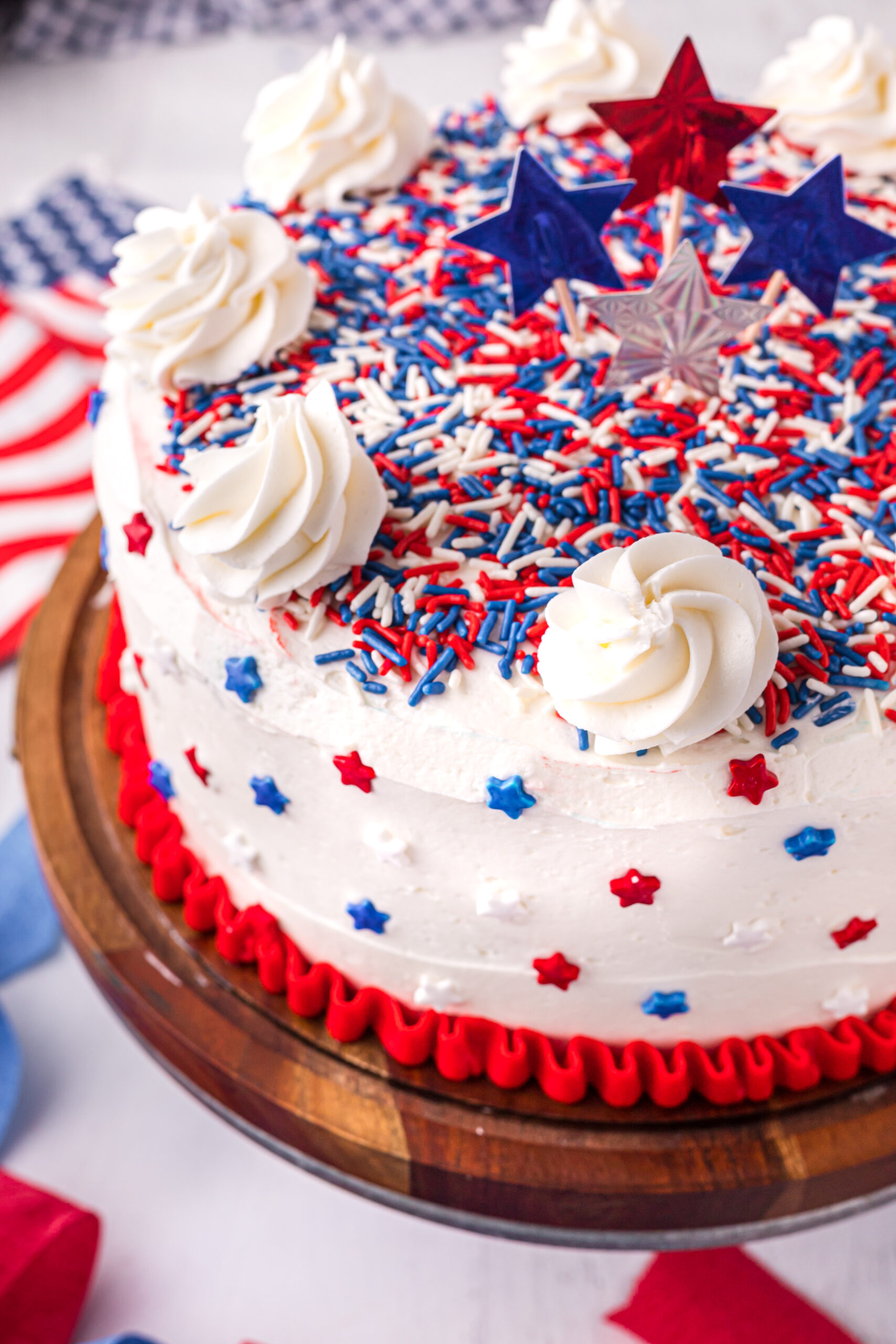 Close up view of 4th of July Cake on a wood cake stand.