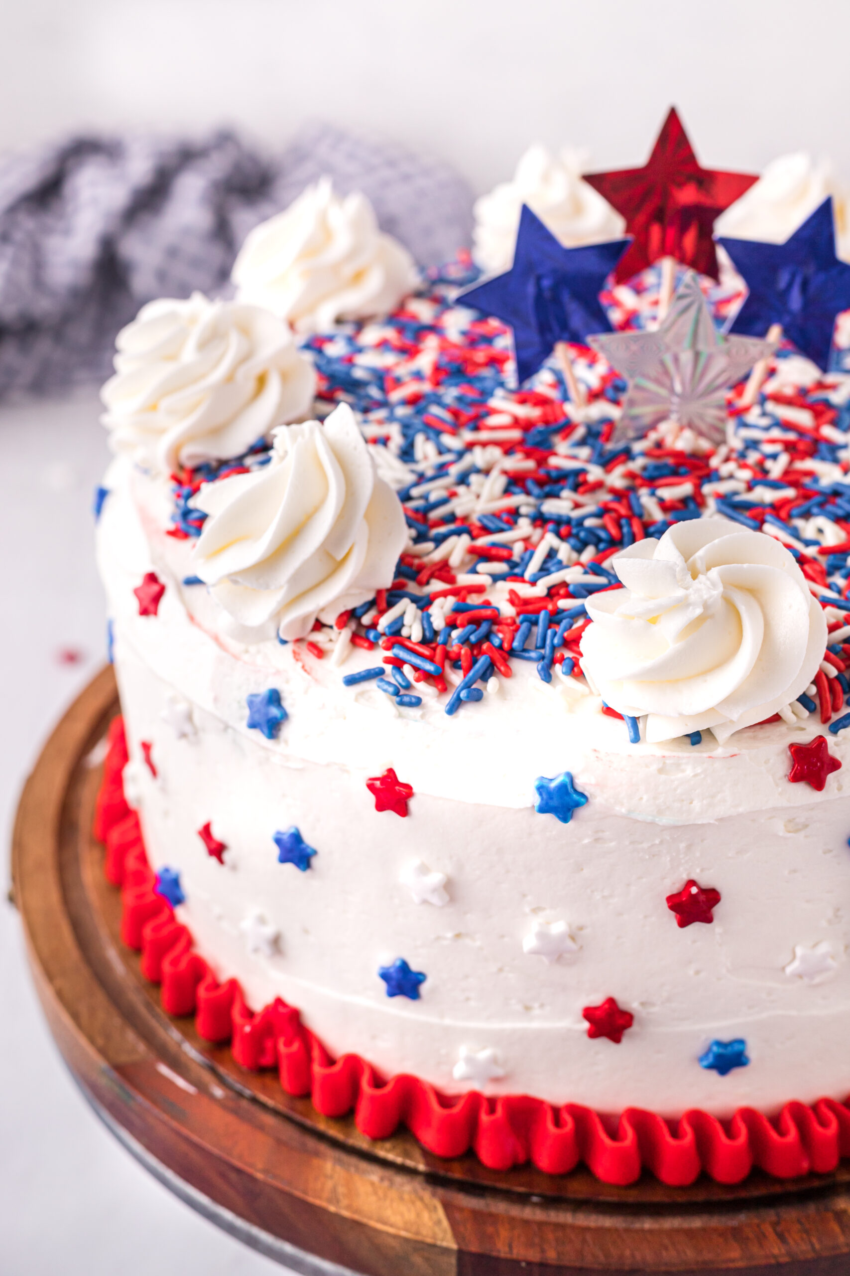 Close up view of 4th of July Cake on a wood cake stand.