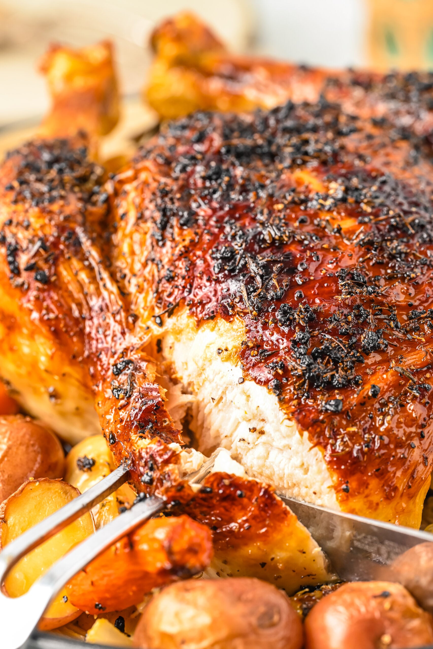 Close up view of Oven Baked Chicken and Vegetables with a slice of chicken being removed.