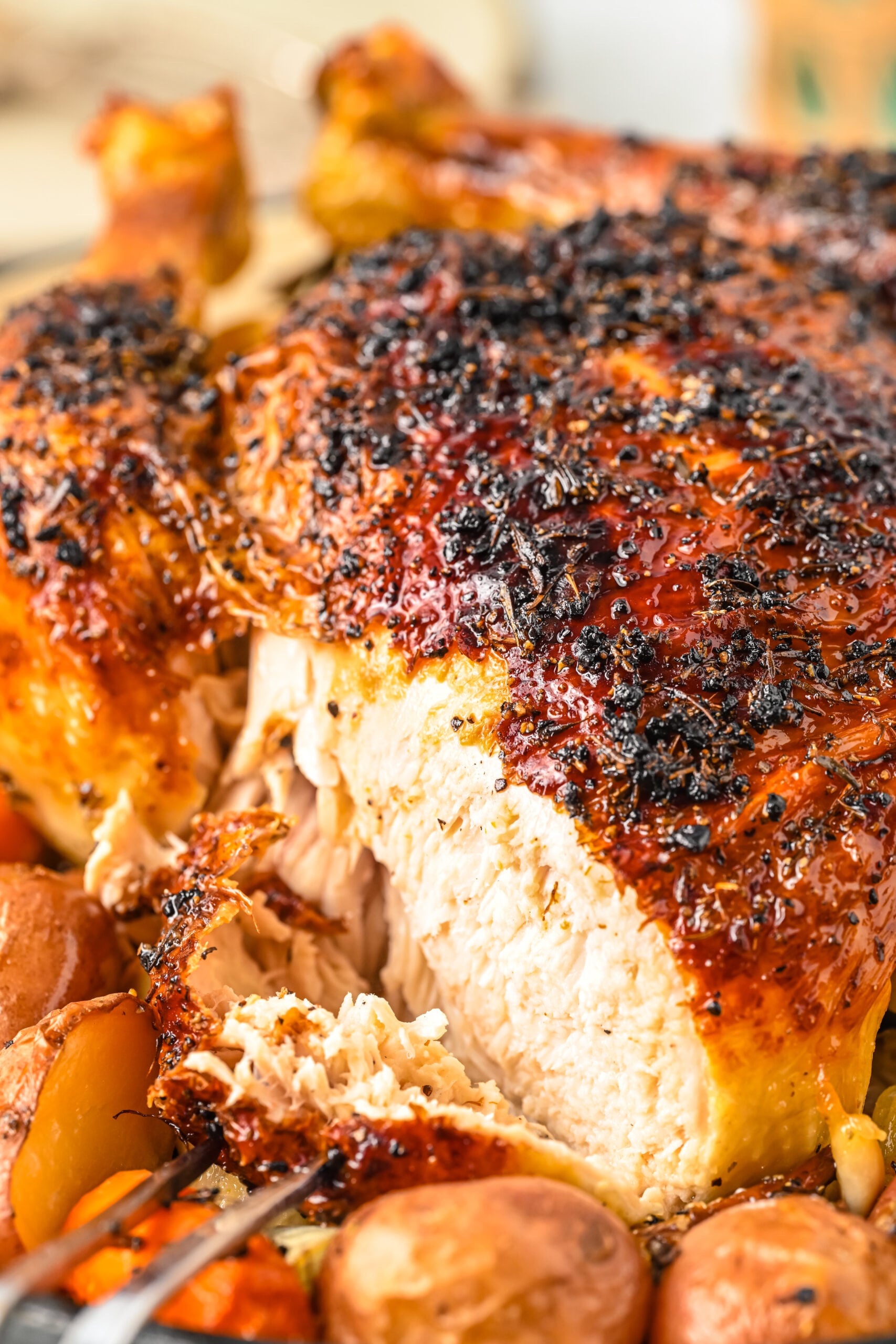 Close up view of Oven Baked Chicken and Vegetables with a slice of chicken being removed.