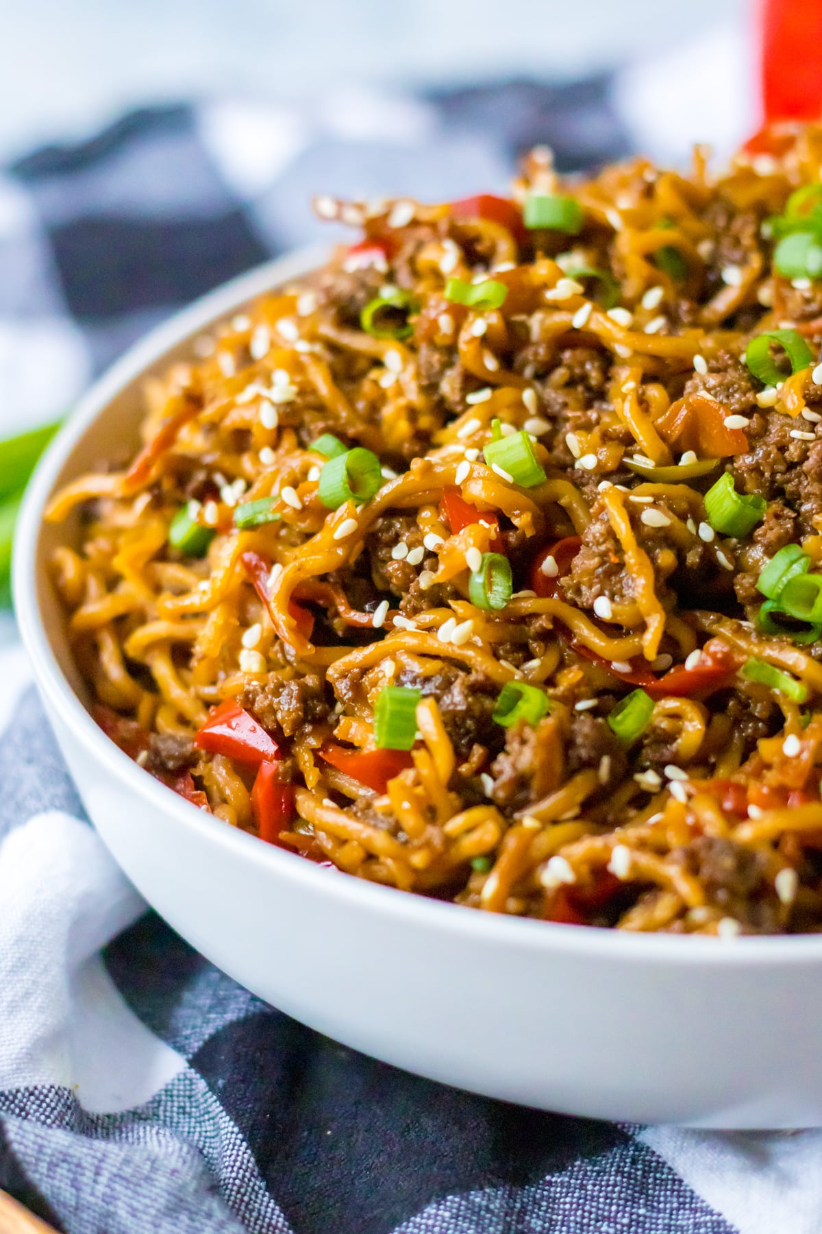 Close up view of Slow Cooker Beef Ramen in a white bowl.