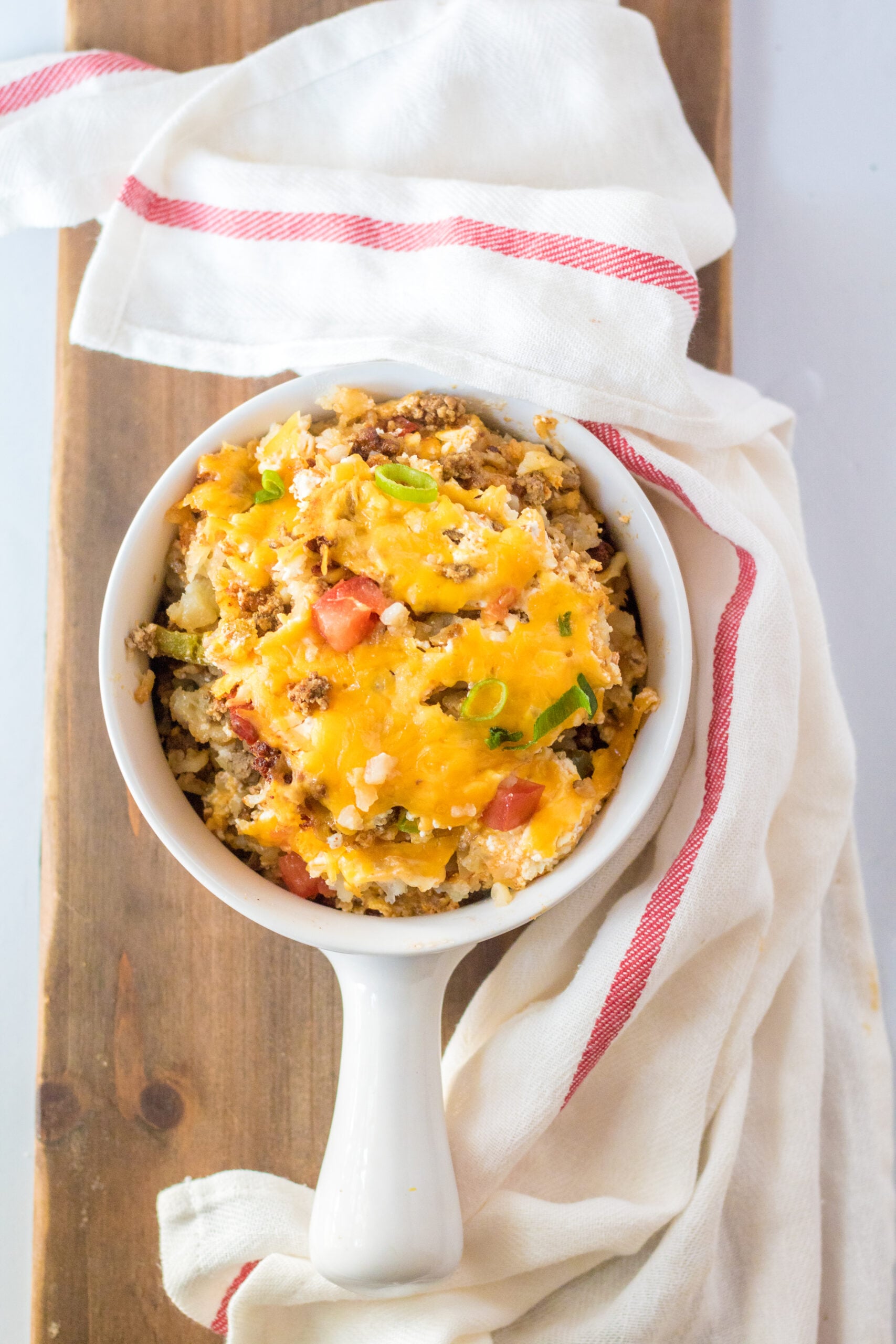 Overhead view of a serving of Slow Cooker John Wayne Casserole in a white bowl.