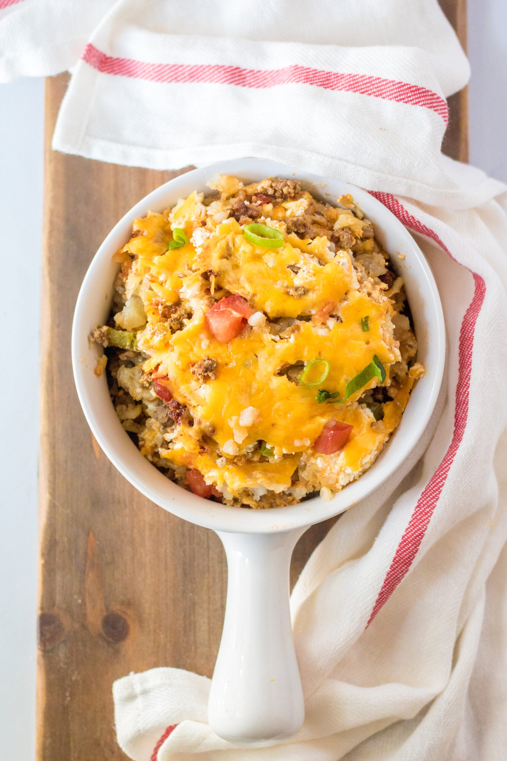 Overhead view of a serving of Slow Cooker John Wayne Casserole in a white bowl.
