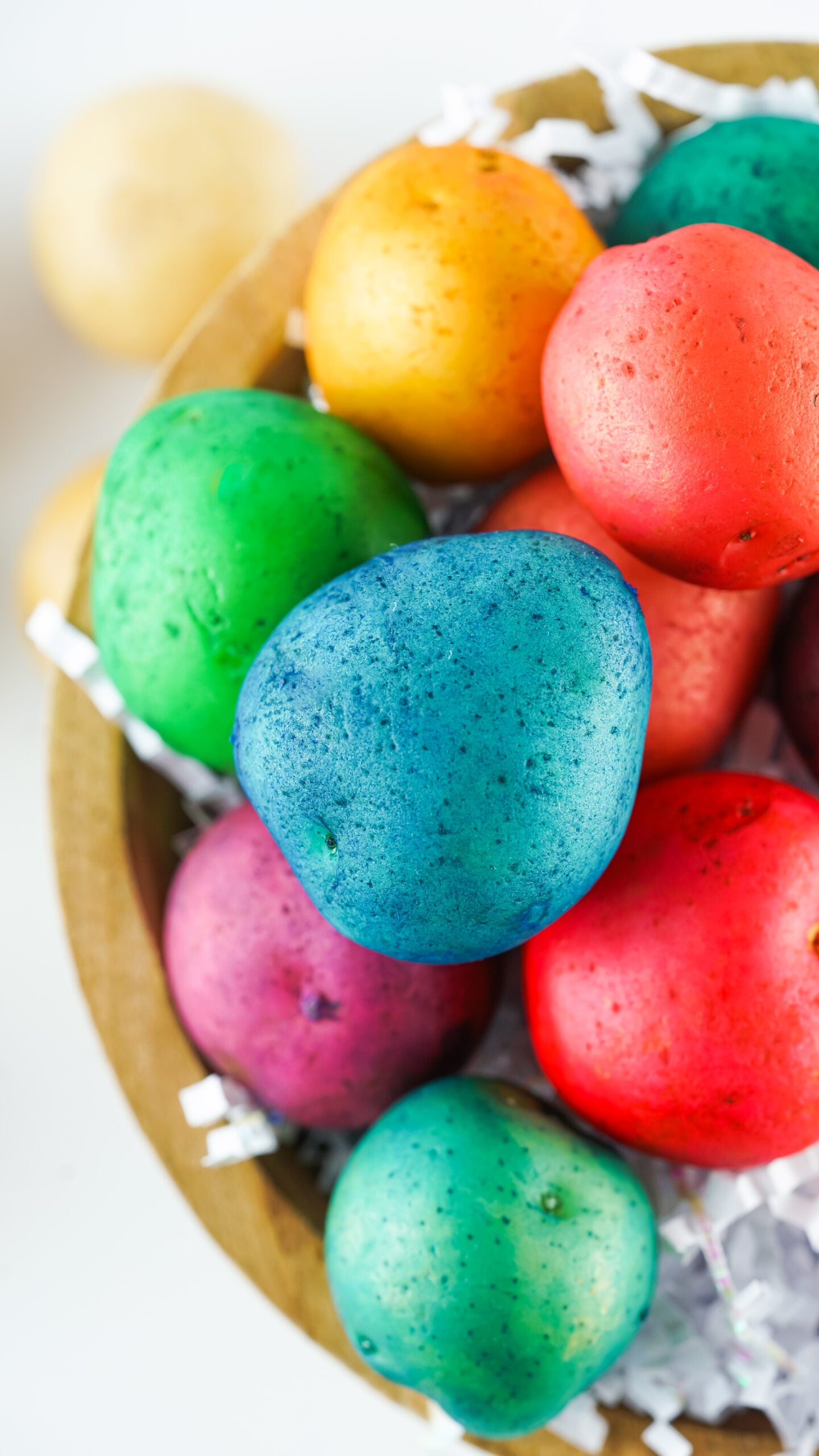 Overhead view of Dyed Easter Egg Potatoes in a brown bowl.