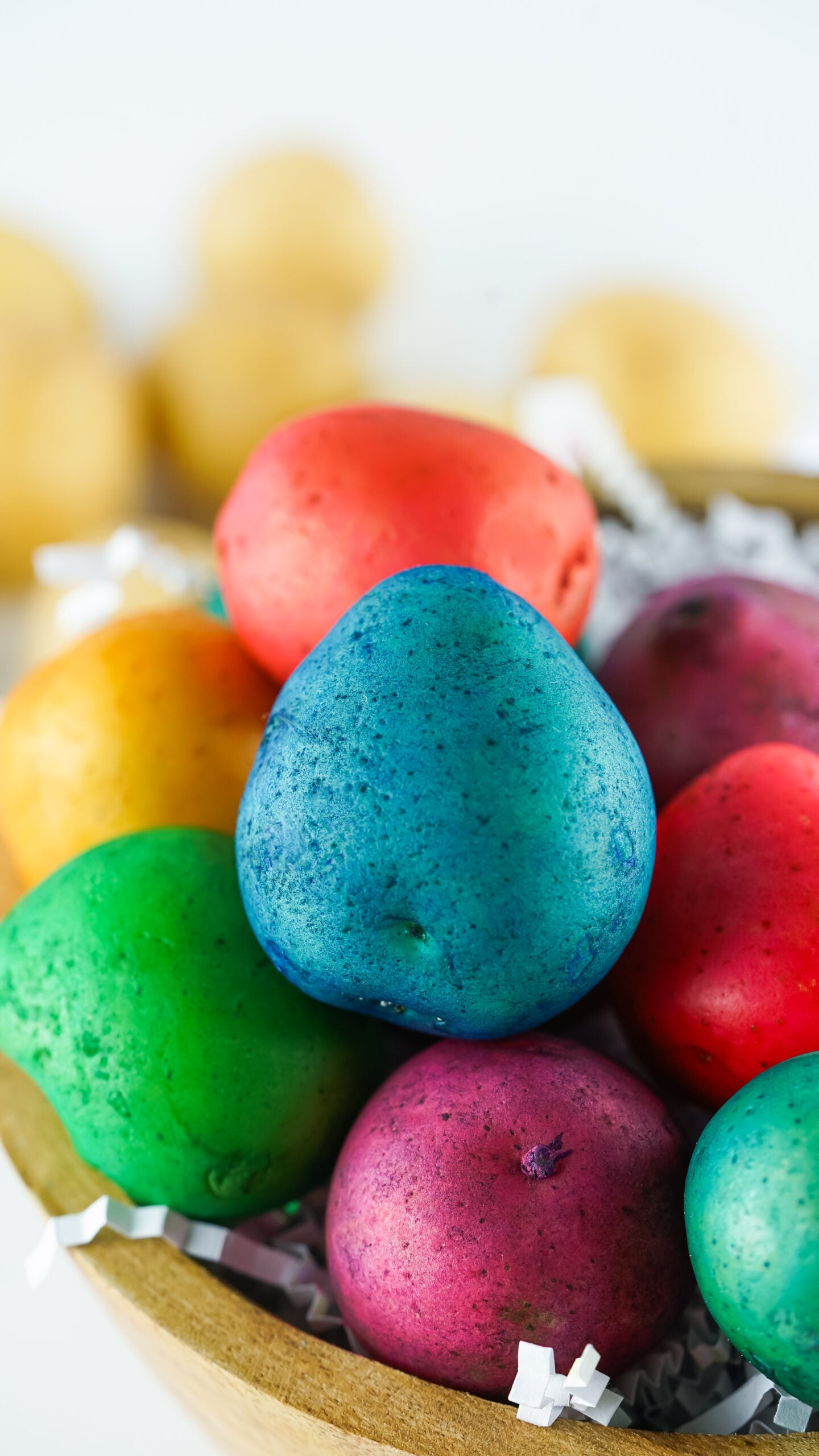 Close up view of Dyed Easter Egg Potatoes in a brown bowl.
