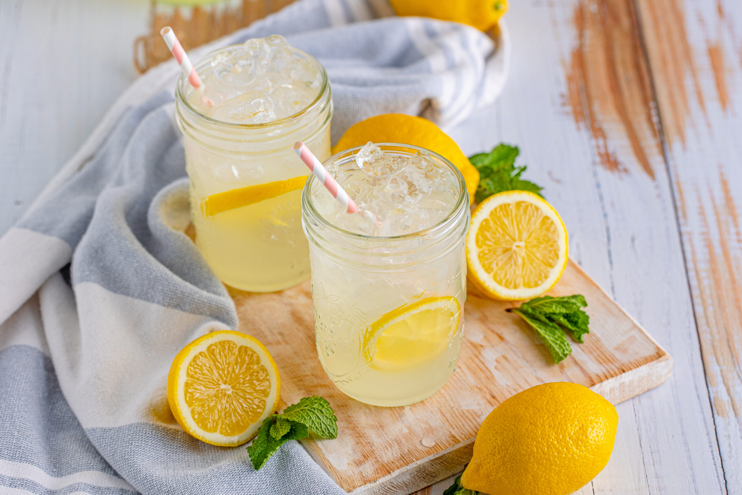 overhead view of Homemade Lemonade in two mason jars garnished with lemon slices.