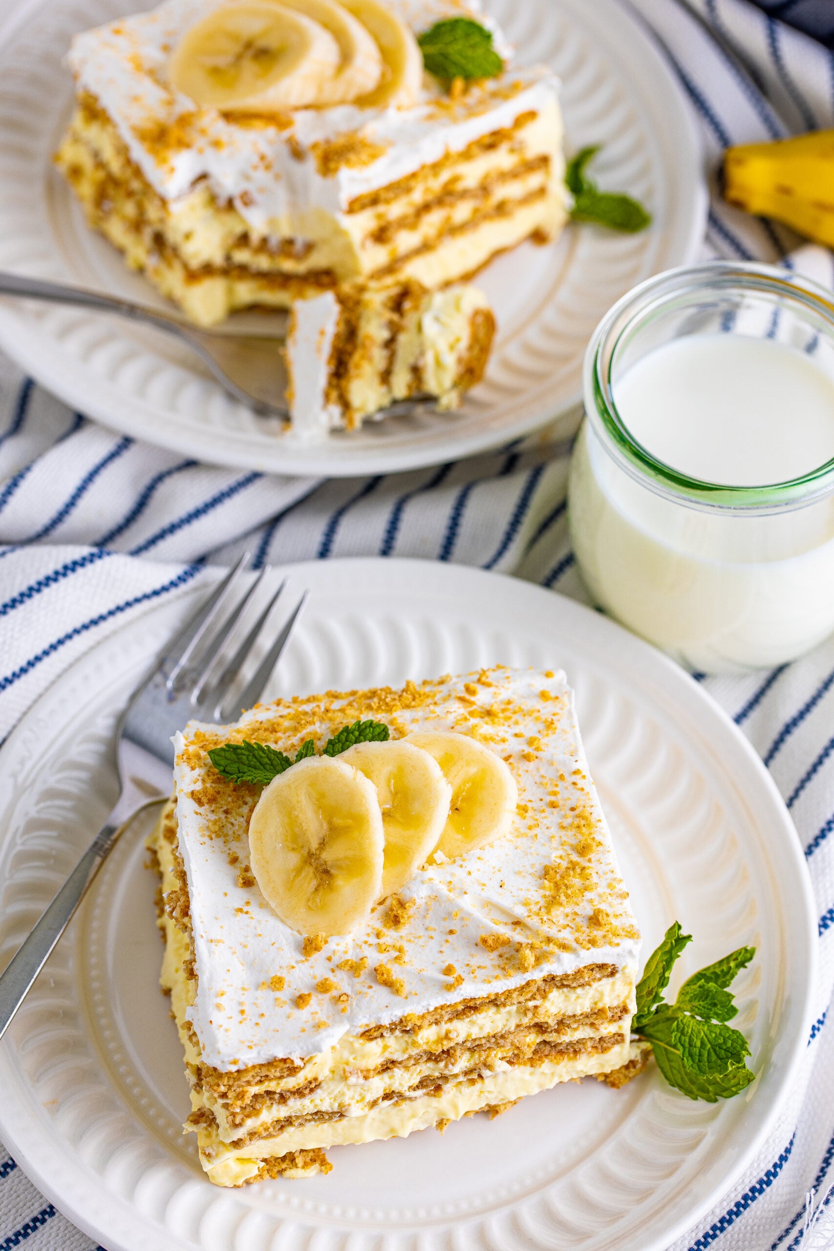 Overhead view of a slice of Banana Icebox Cake on a white plate.