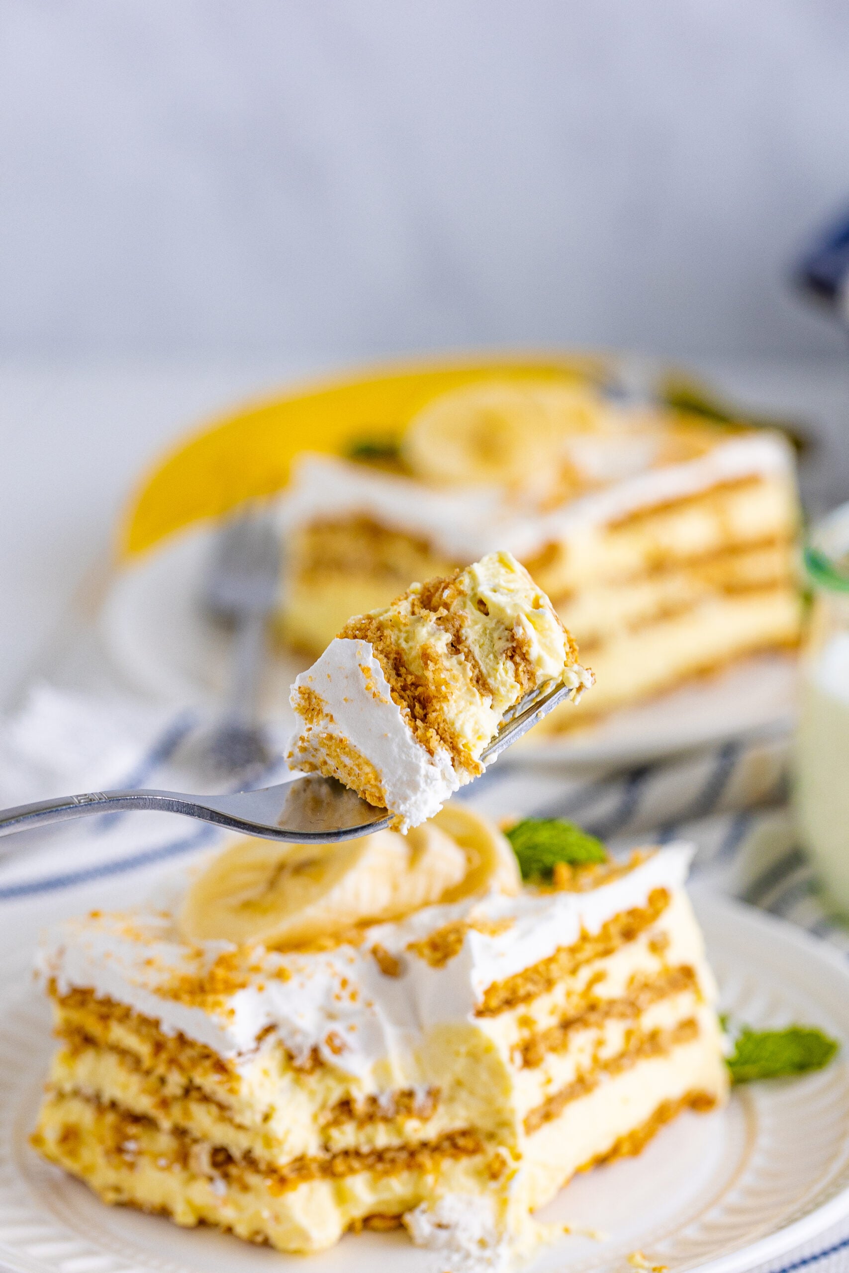 Side view of a bite of Banana Icebox Cake on a silver fork.