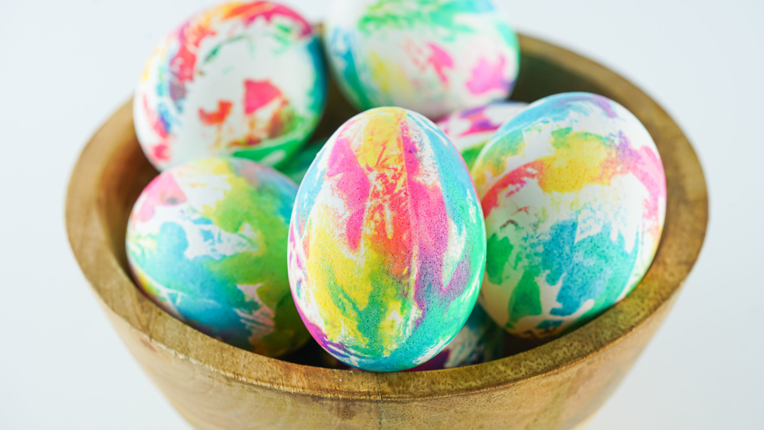 Front view of Tie Dye Easter Eggs in a brown bowl.