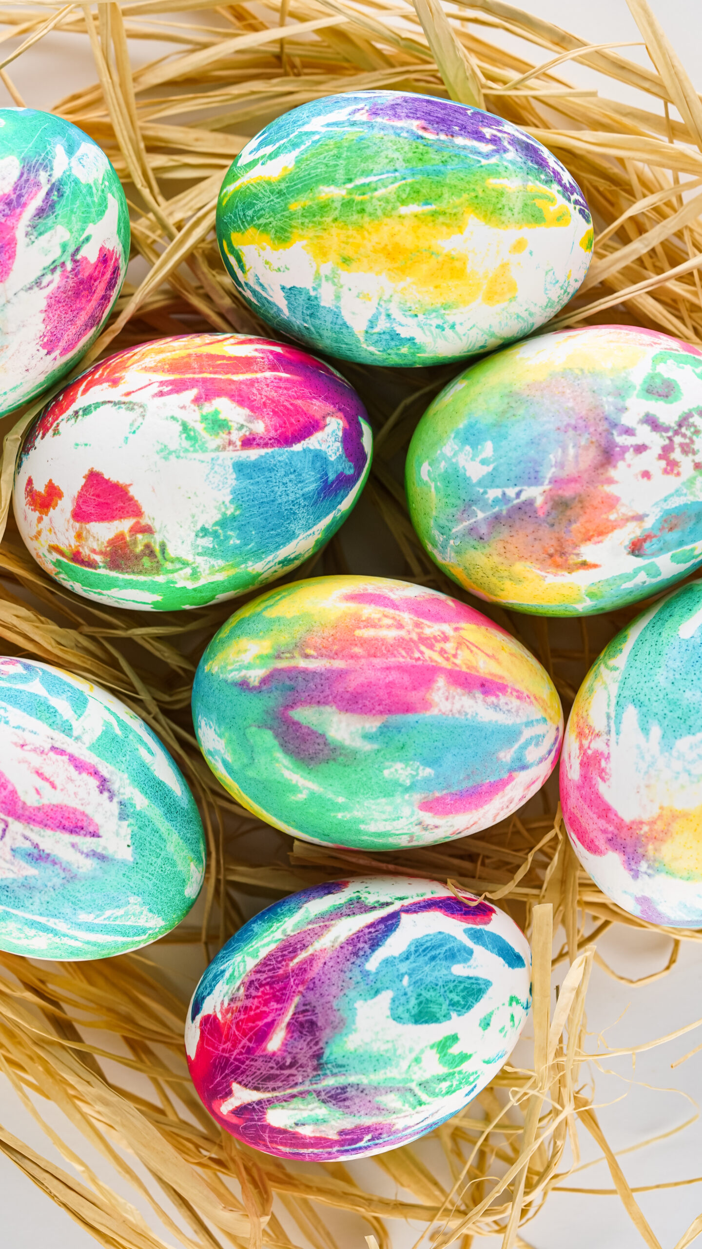 Overhead view of Tie Dye Easter Eggs on a bed of Easter grass.