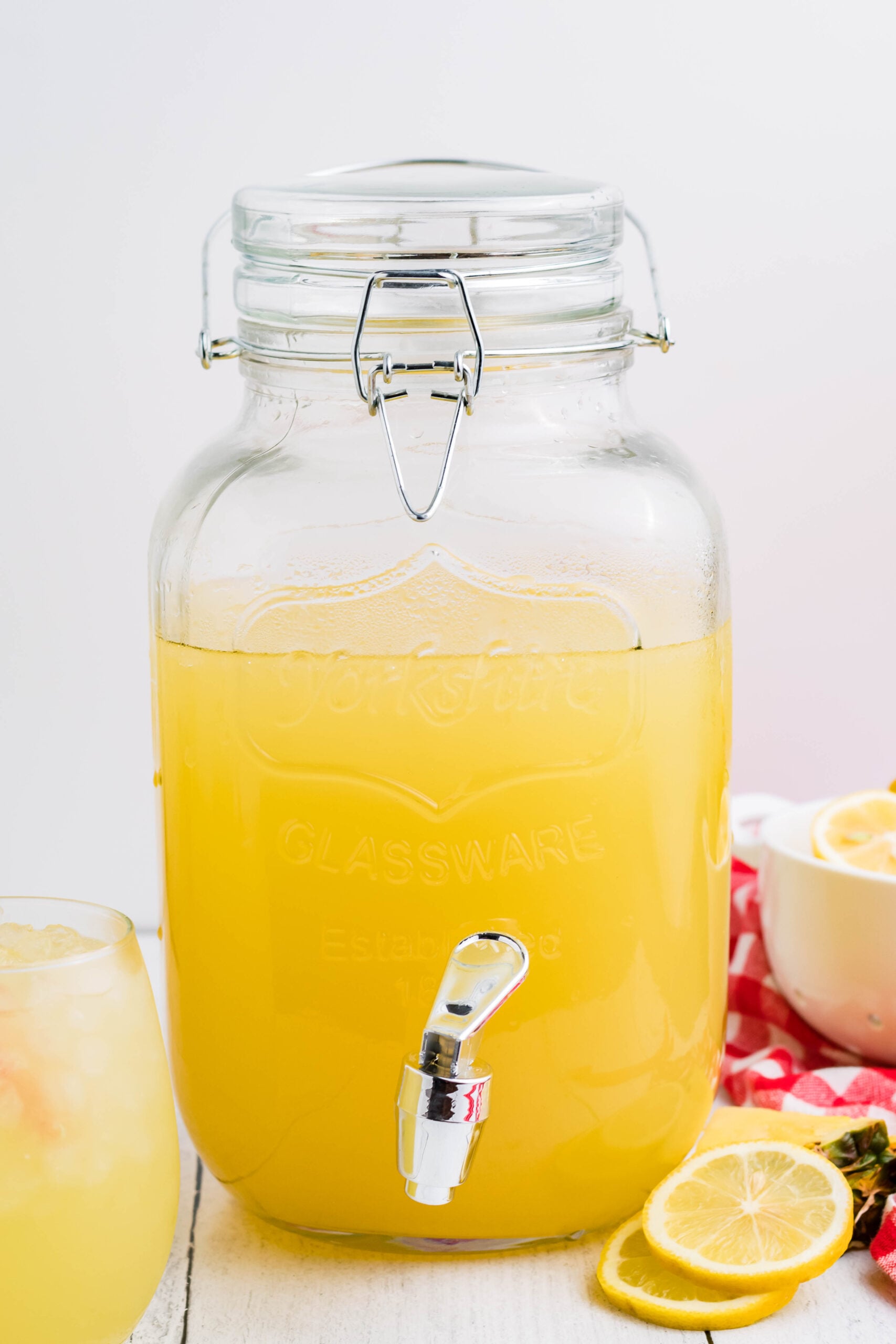 Front view of Pineapple Vodka Lemonade in a drink dispenser. 
