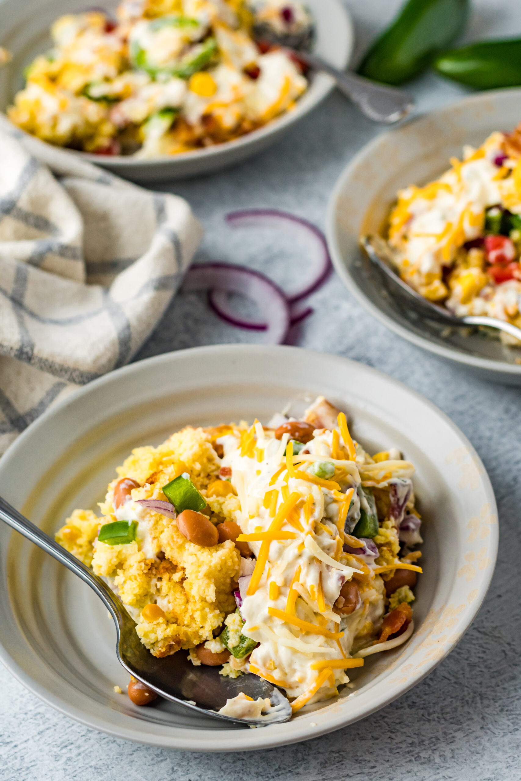 Front view of a serving of Cornbread Salad in a gray bowl.