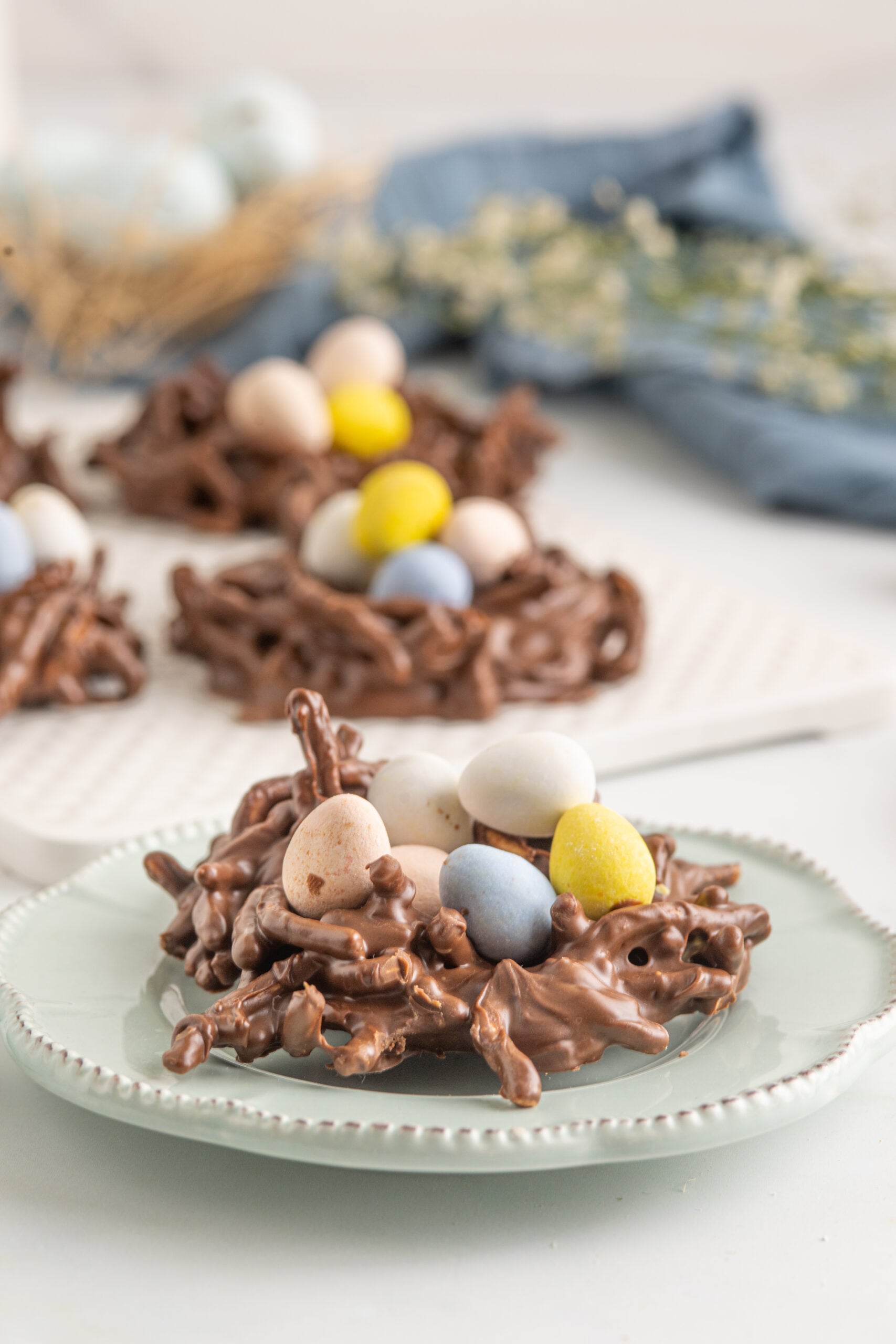 A Bird's Nest Cookie on a teal plate.