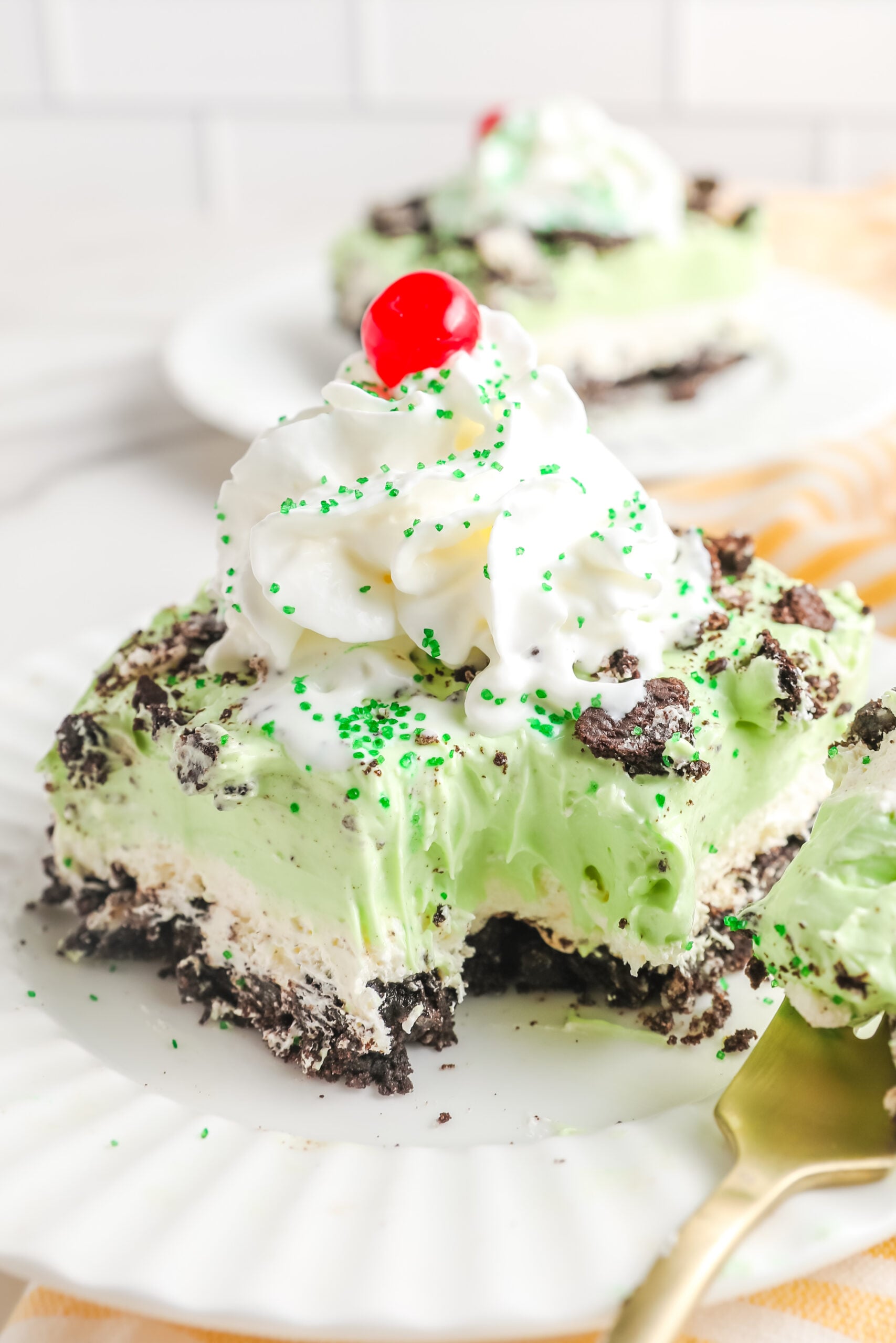 Close of view of the shamrock lasagna with a bite removed showing the creamy layers