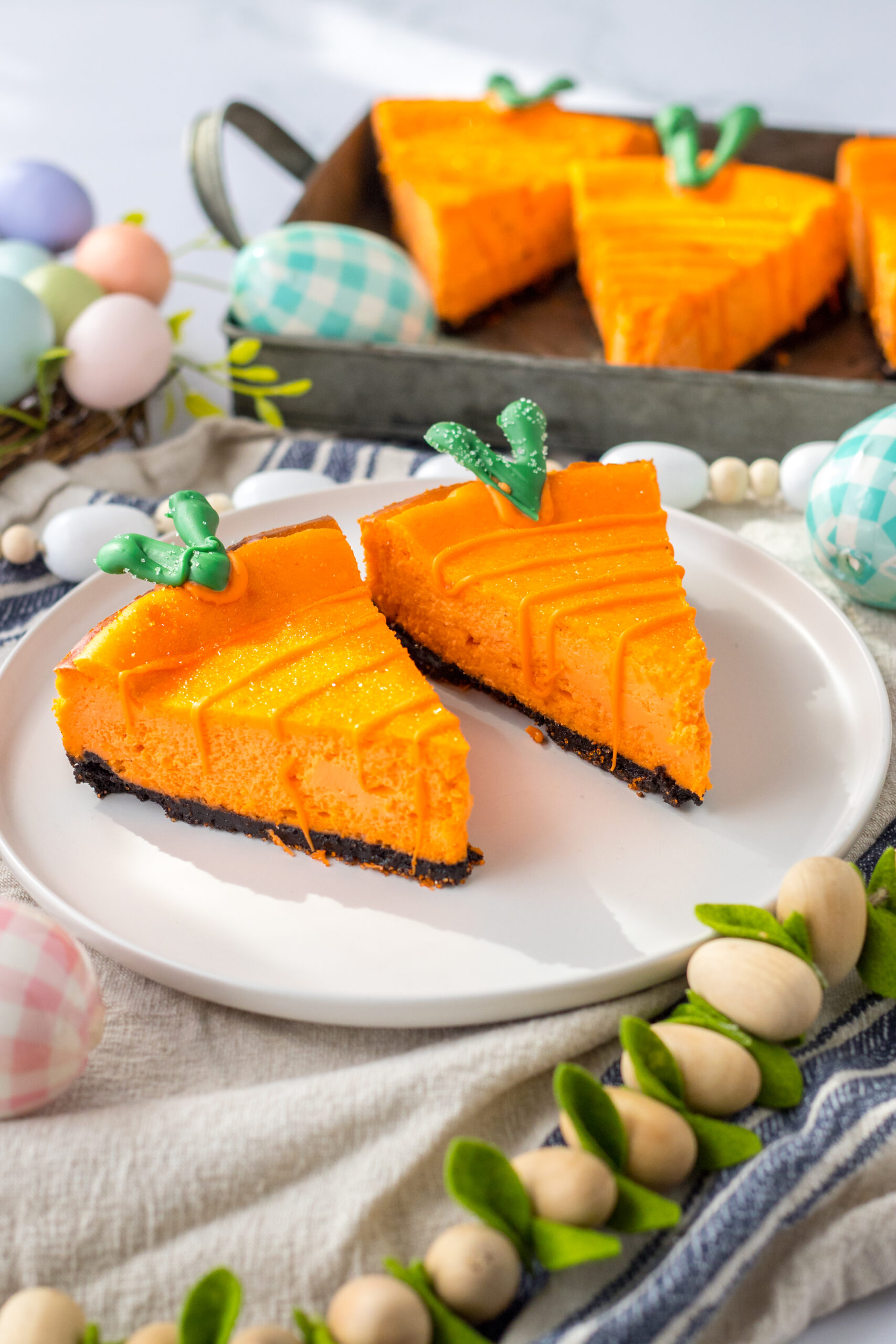 Two Cheesecake Carrots on a white plate.
