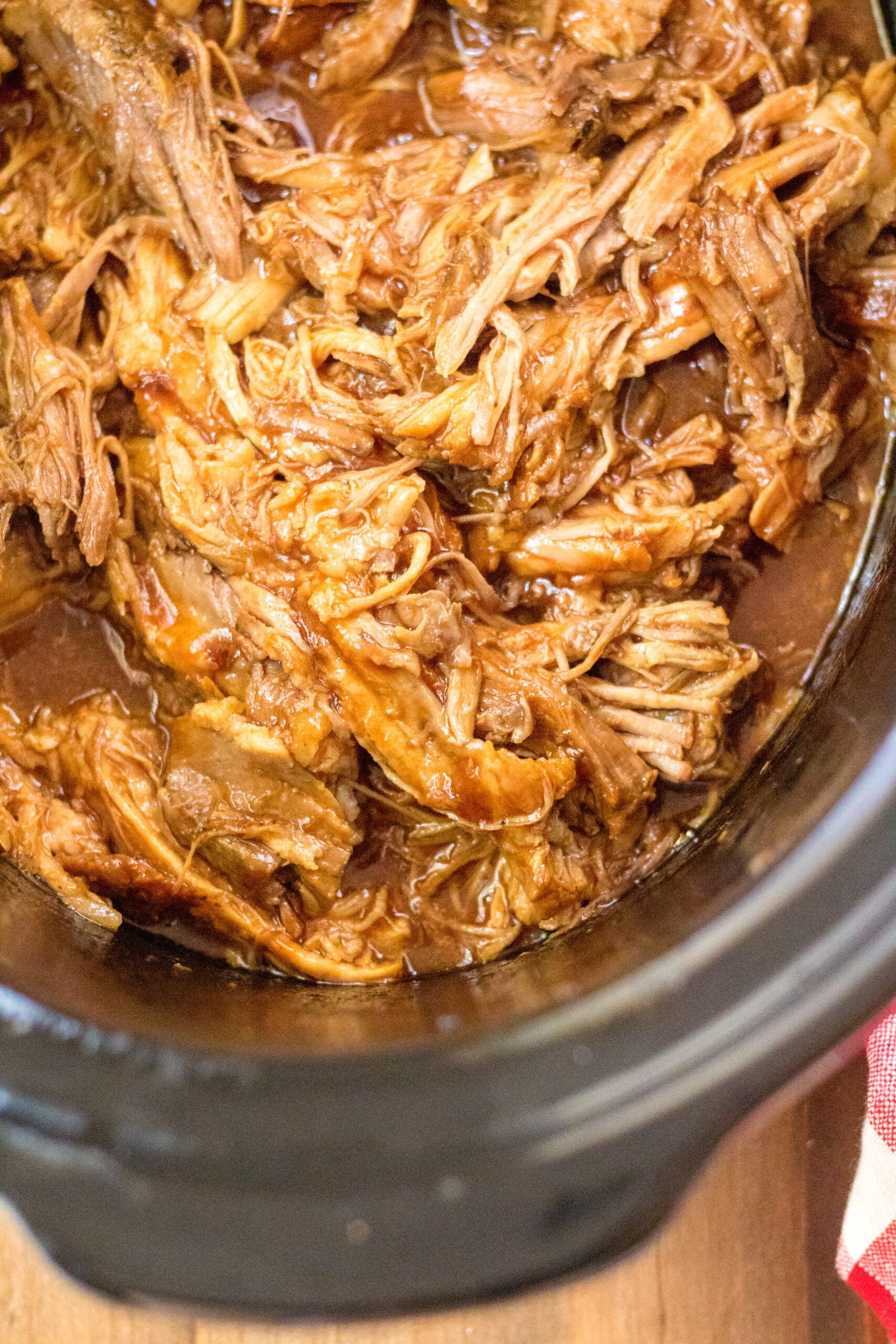 Close up view of Slow Cooker Cola Pulled Pork in a crock pot.