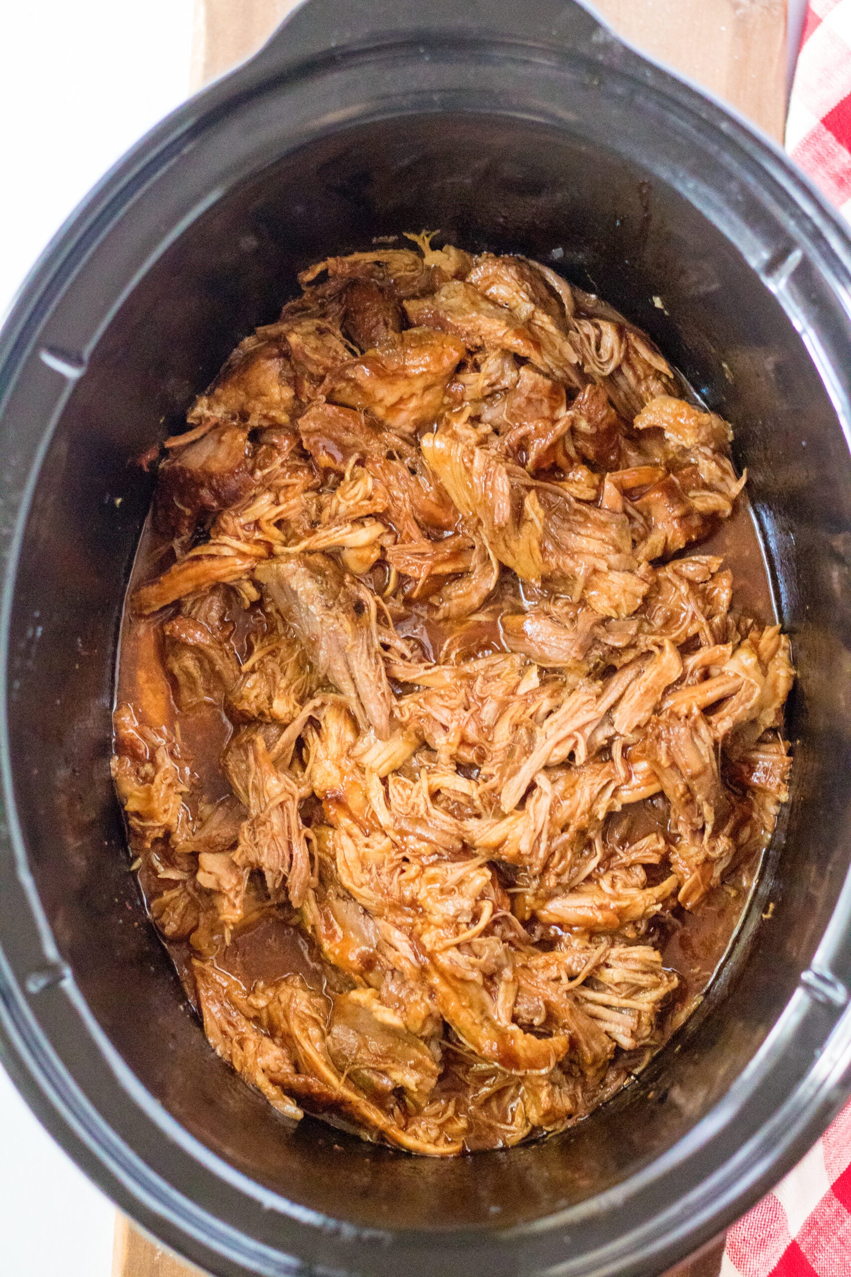 Overhead view of Slow Cooker Cola Pulled Pork in a crock pot.