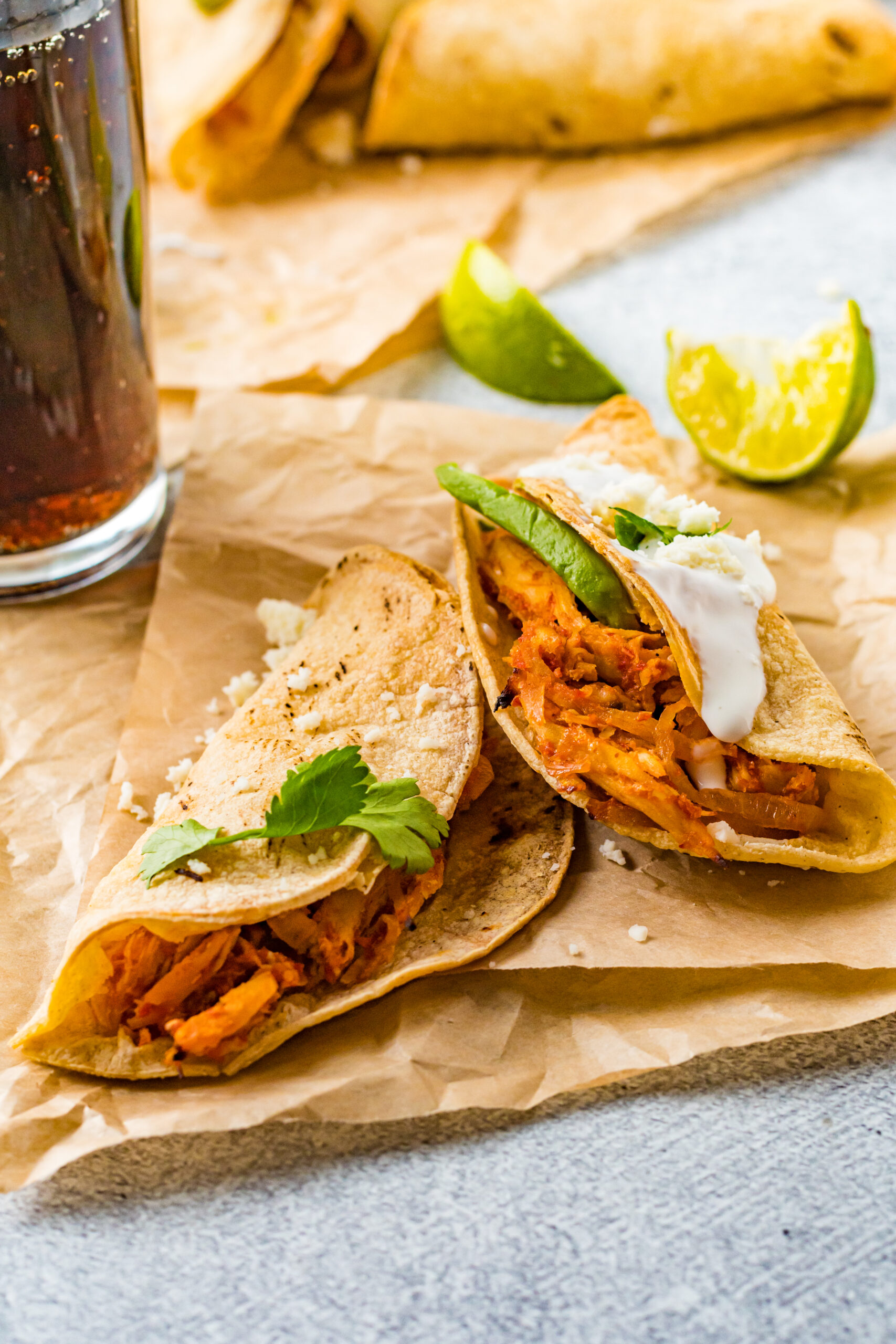 Front view of two Crispy Tinga Tacos on a piece of parchment paper.