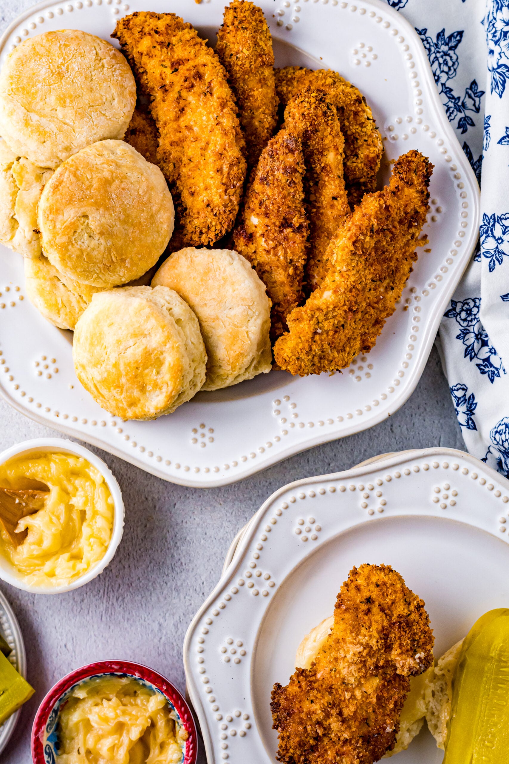 Overhead view of Honey Butter Chicken Biscuit unassembled on a white dish.