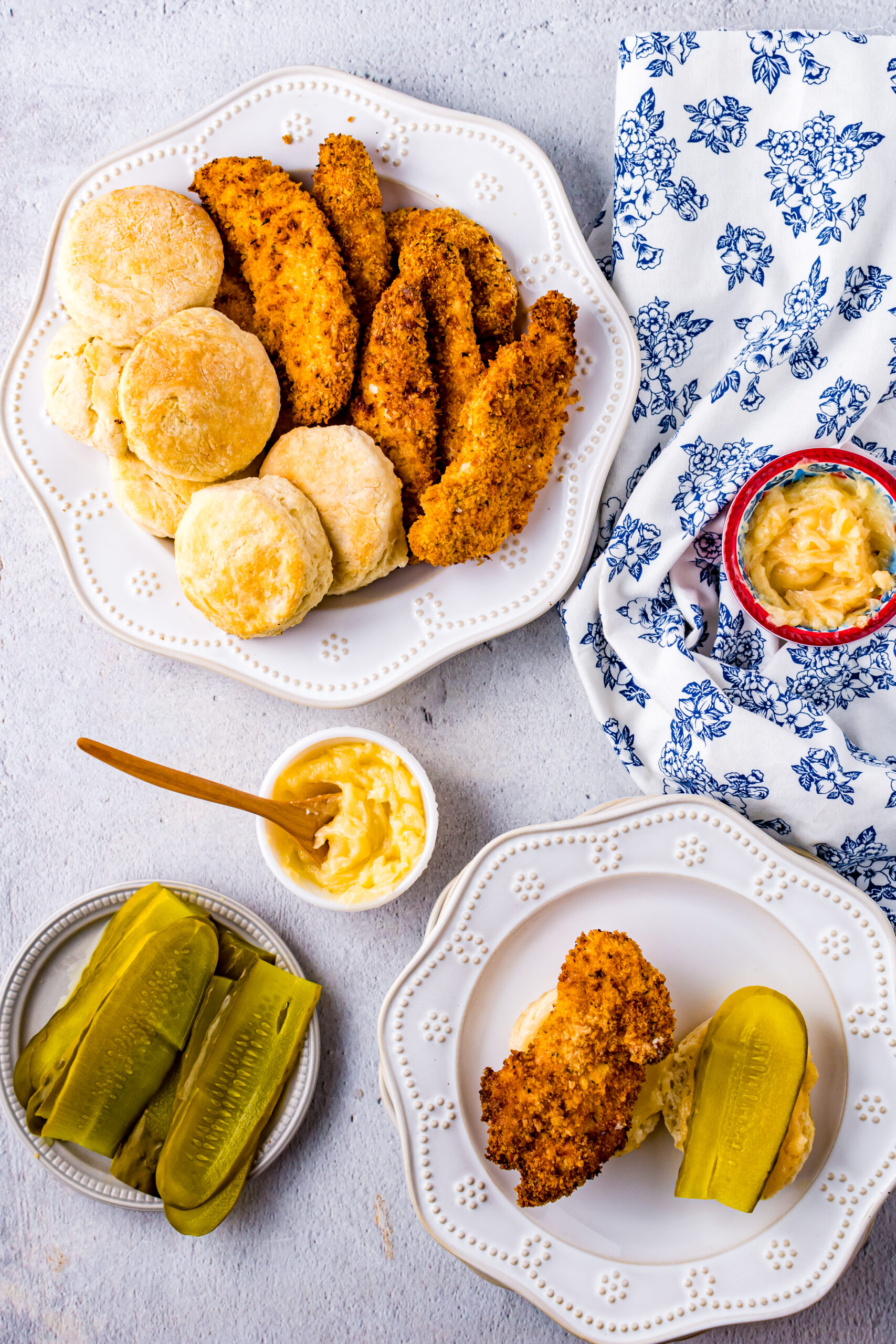 Overhead view of Honey Butter Chicken Biscuit unassembled on a white dish.