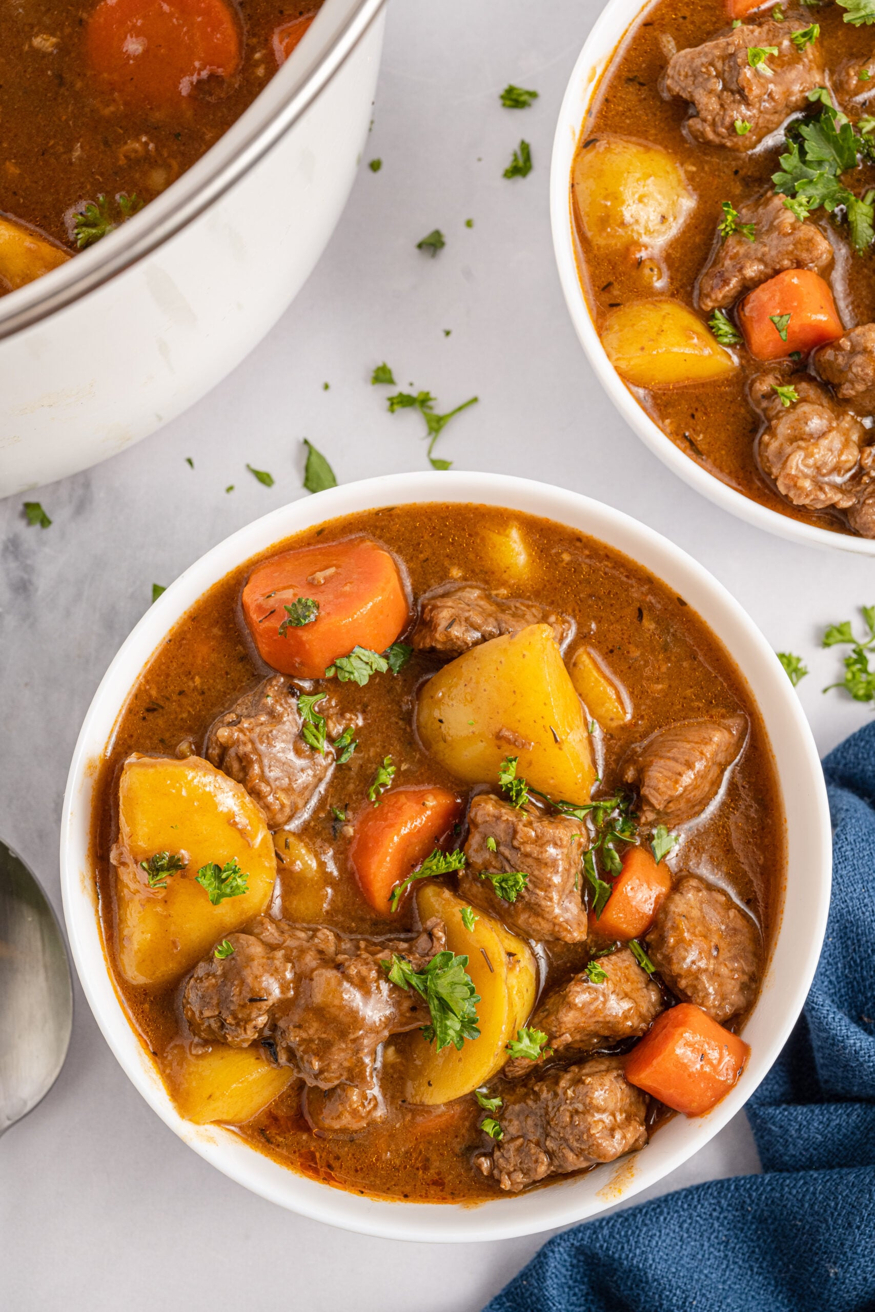 Irish Stew in a white bowl with a blue linen.