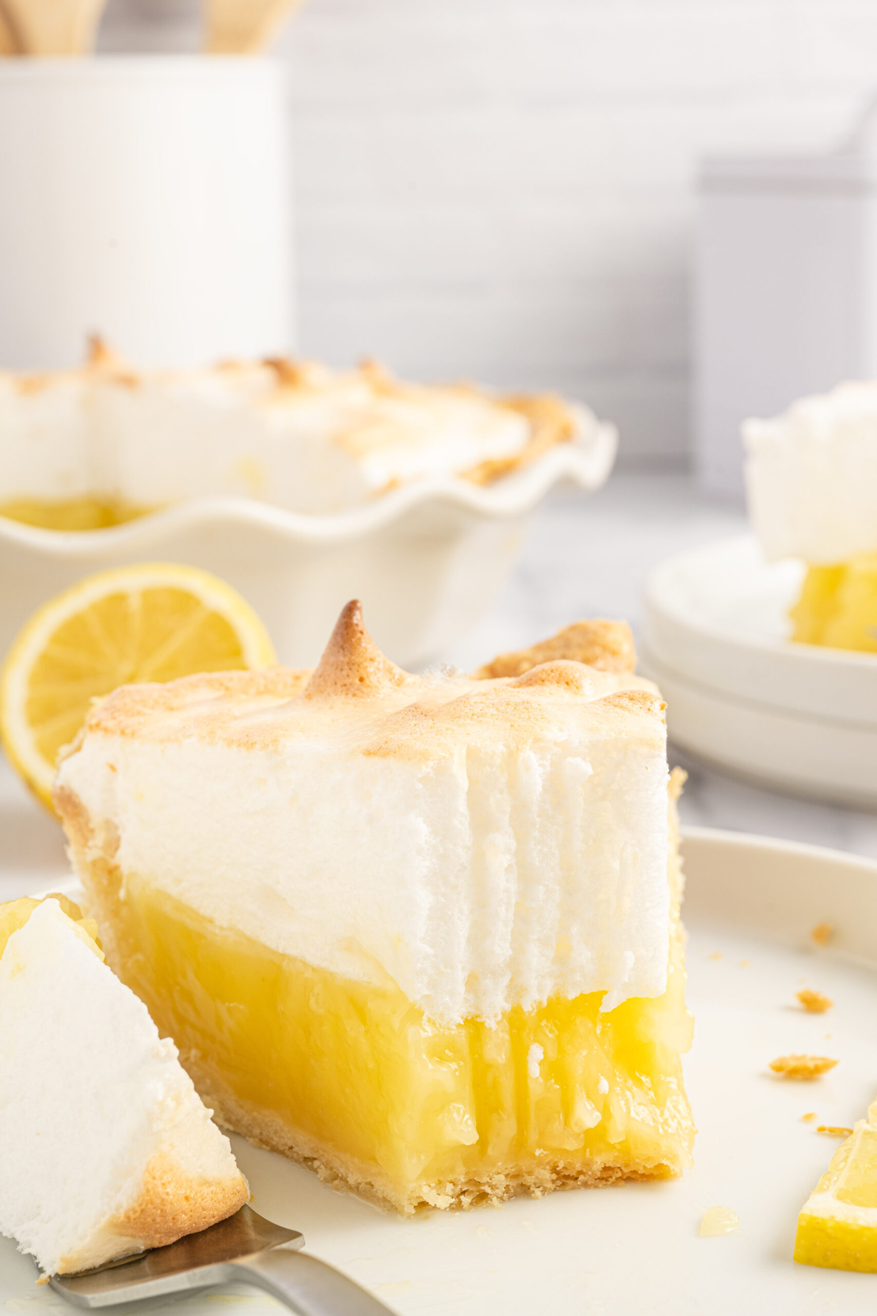 A close up bite shot of the fresh lemon meringue pie. 