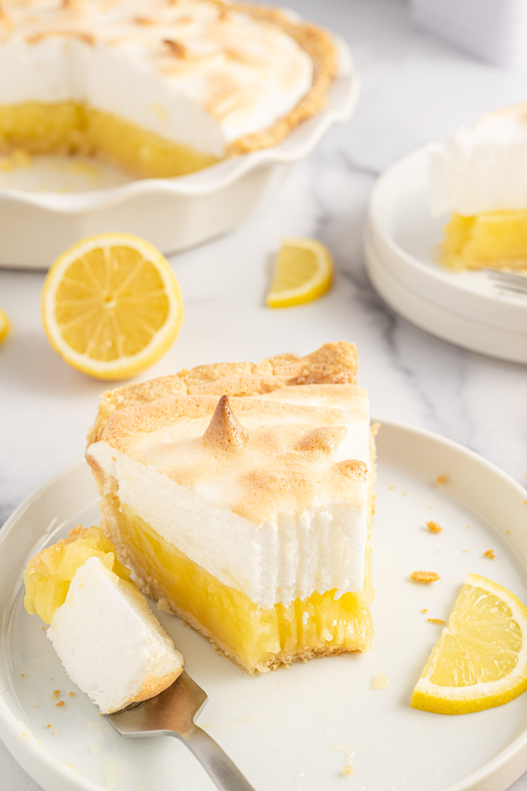 A close up bite shot of the fresh lemon meringue pie. 