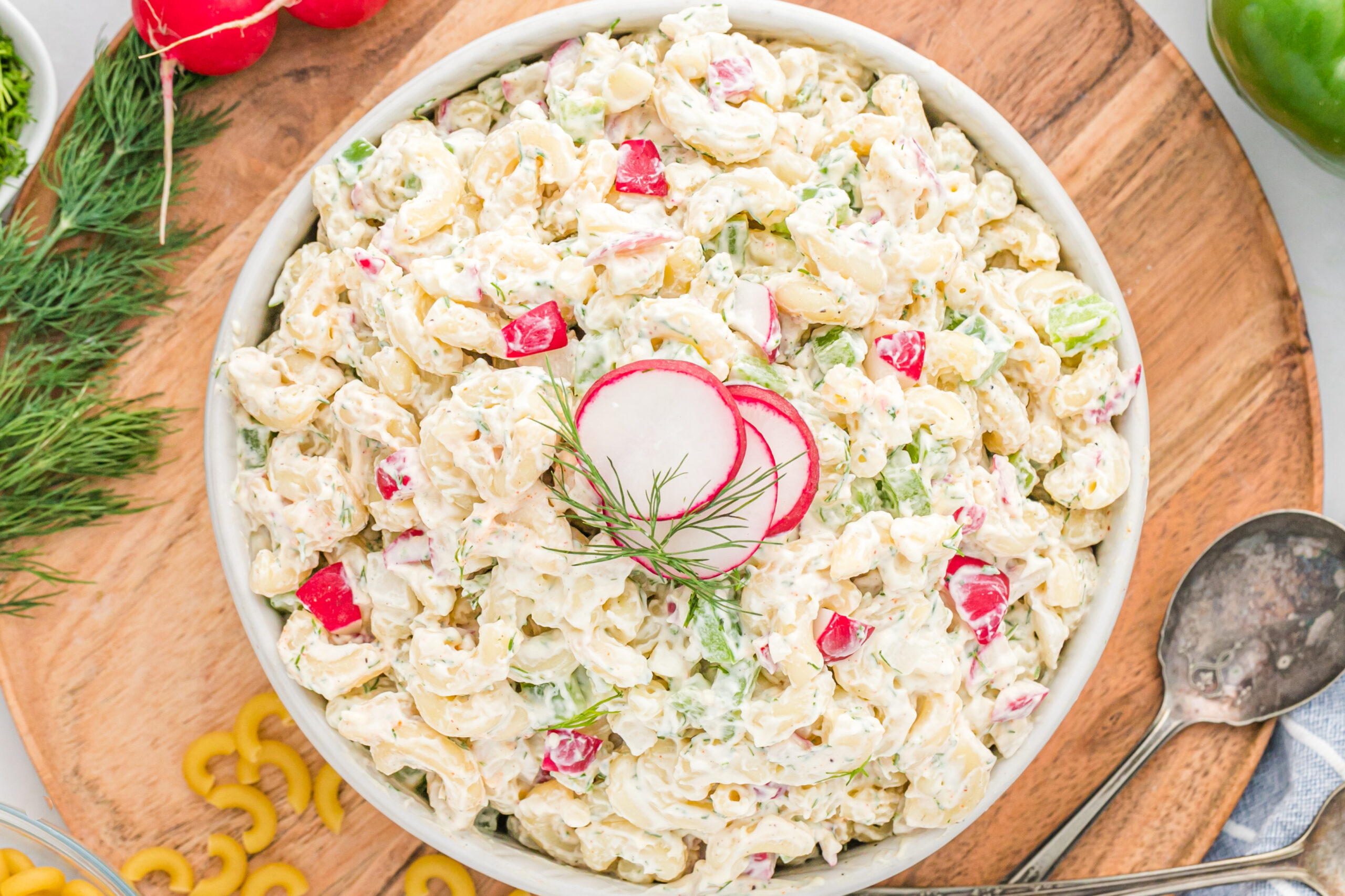 Overhead view of Macaroni Dill Pasta Salad in a white serving bowl.