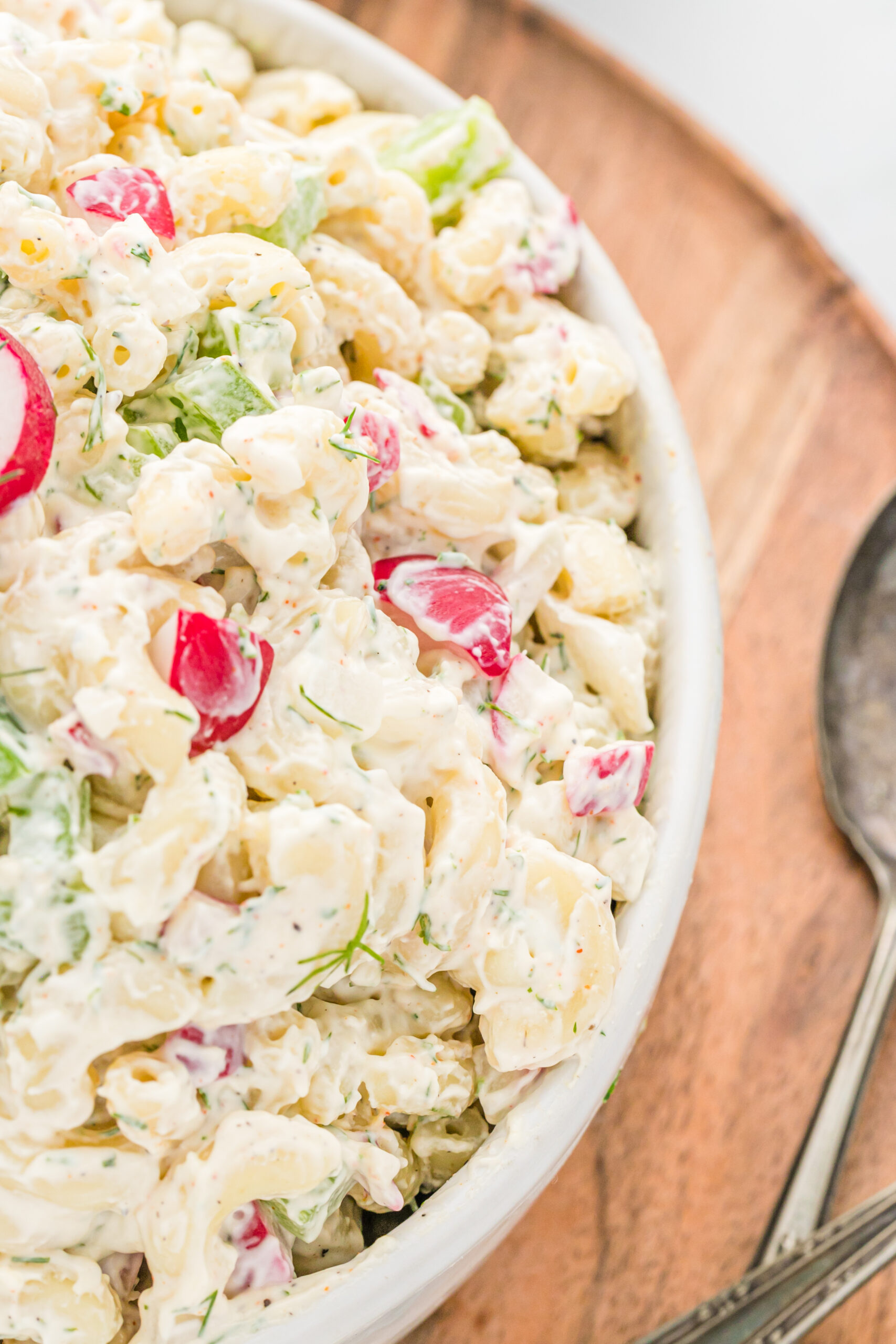 Close up view of Macaroni Dill Pasta Salad in a white serving bowl.