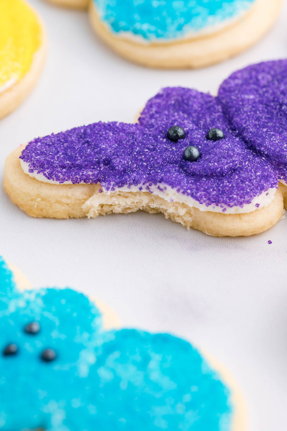 A purple Bunny Cookie with a bite taken out of the ear.