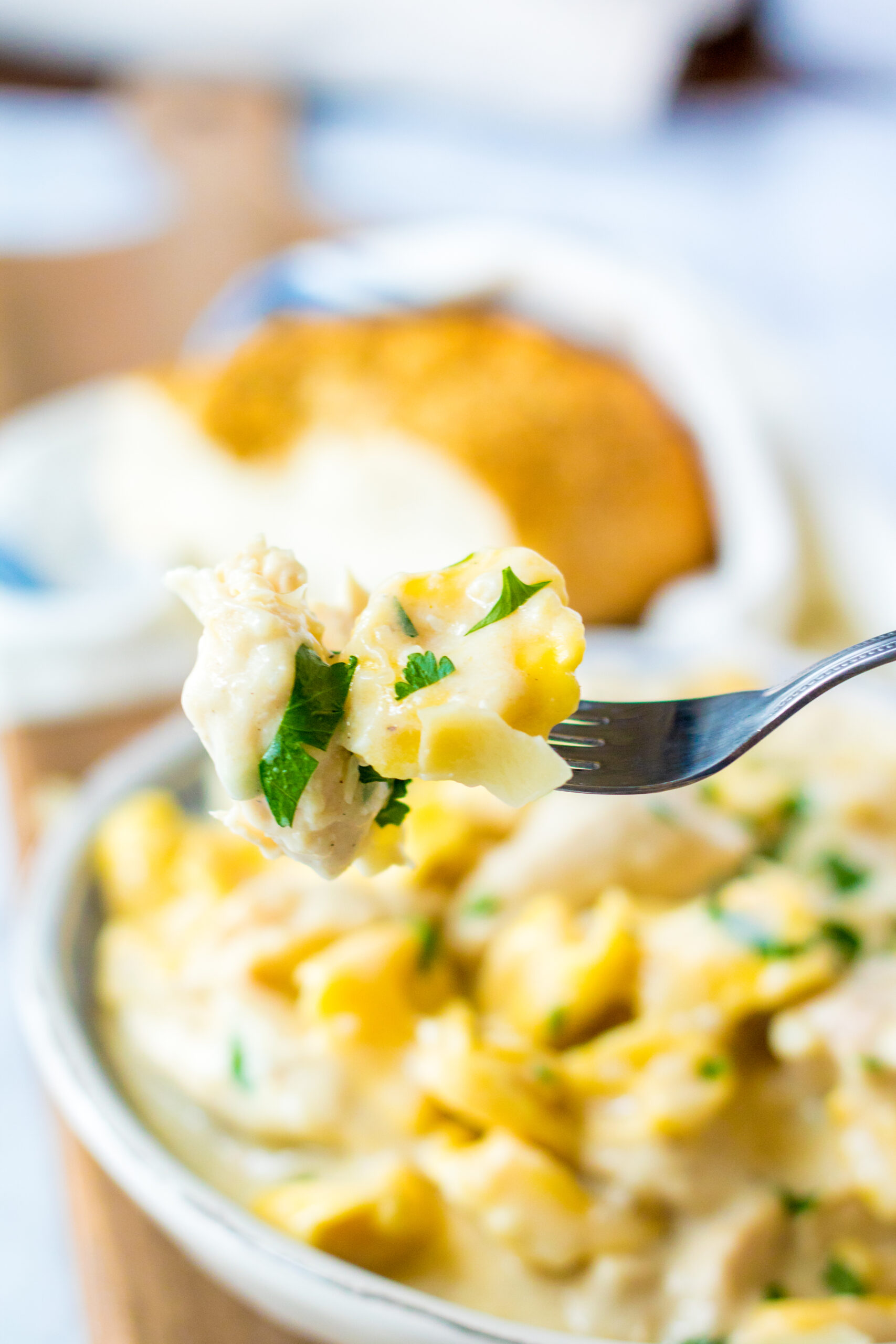 Front view of a bite of Slow Cooker Chicken Tortellini on a silver fork.