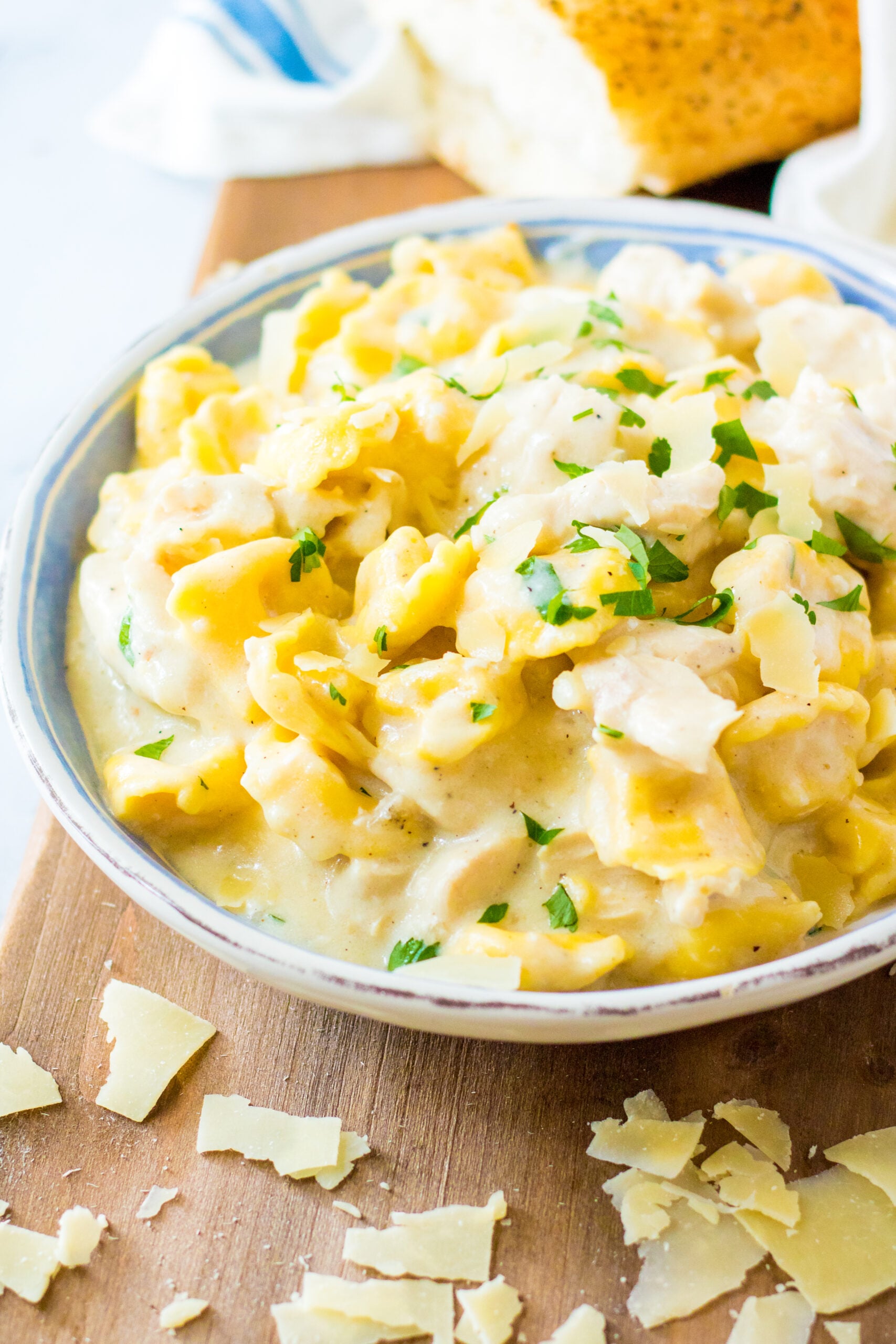 Front view of Slow Cooker Chicken Tortellini in a white and blue bowl.