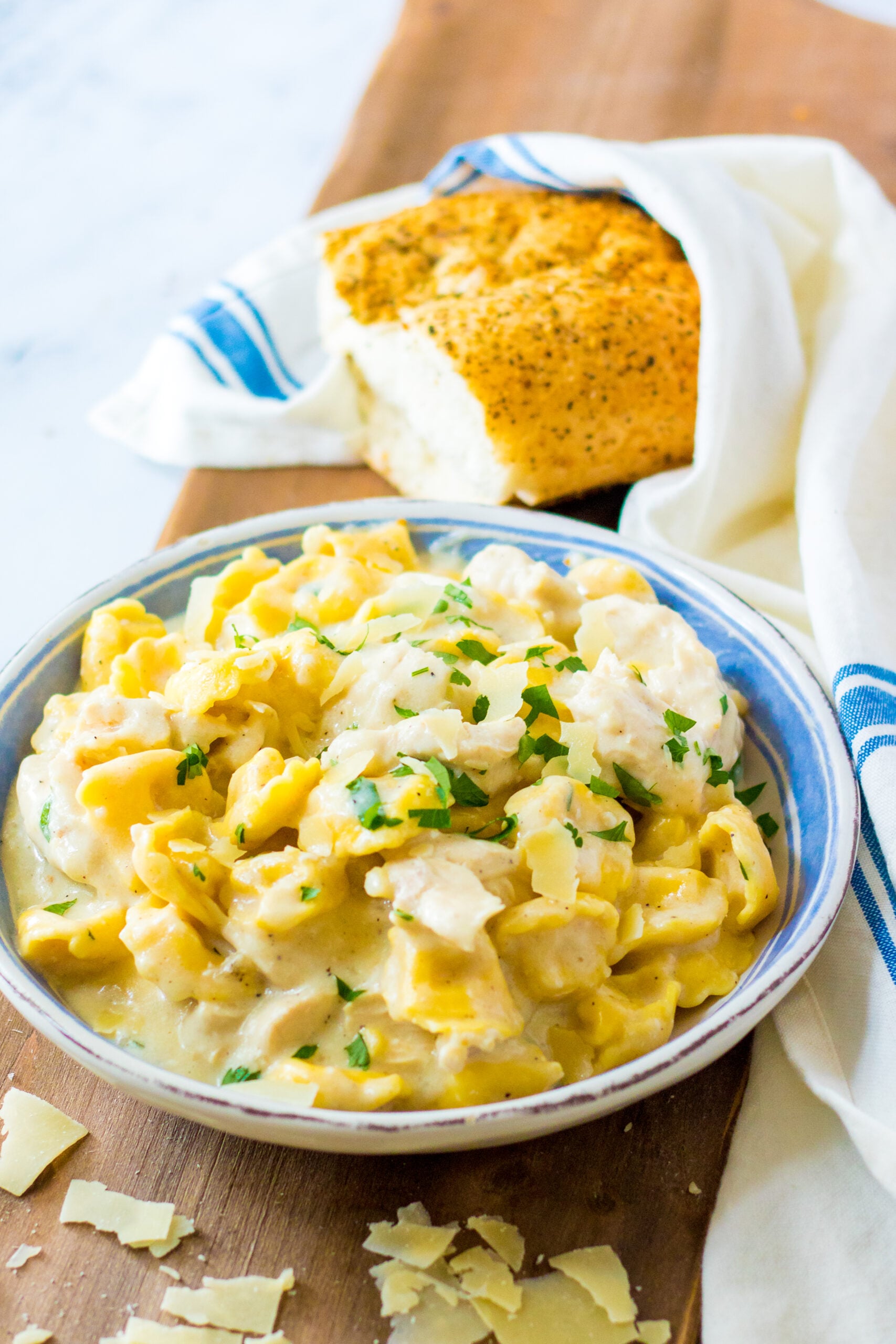 Front view of Slow Cooker Chicken Tortellini in a white and blue bowl.