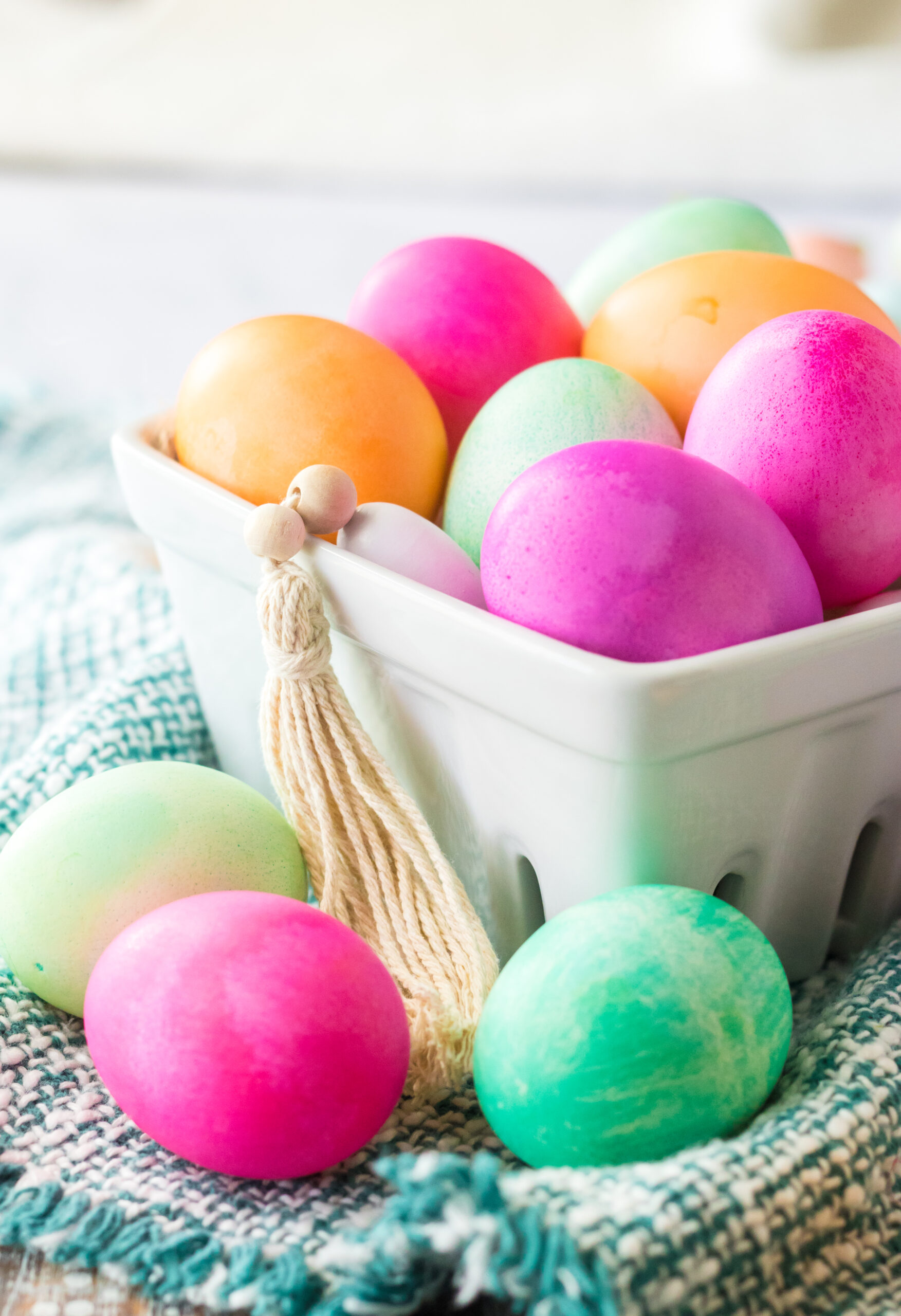 Close up shot of Dyed Easter Eggs in a white glass container.