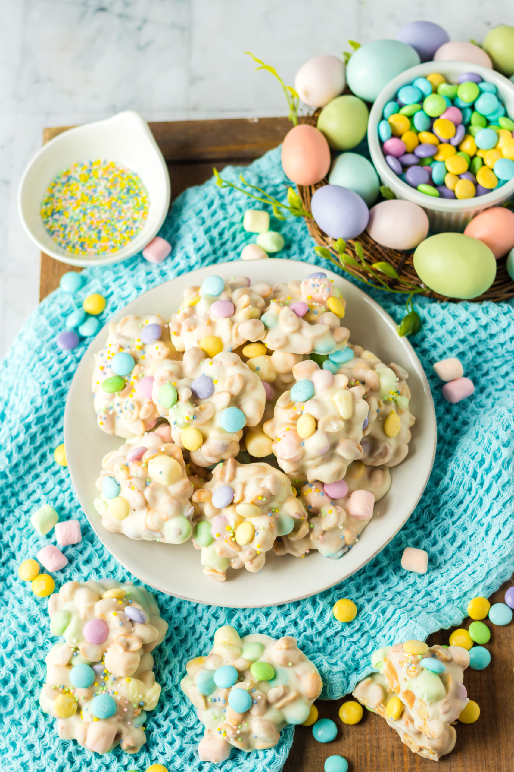 Slow Cooker Easter Candy stacked on a white plate on top of a teal linen.
