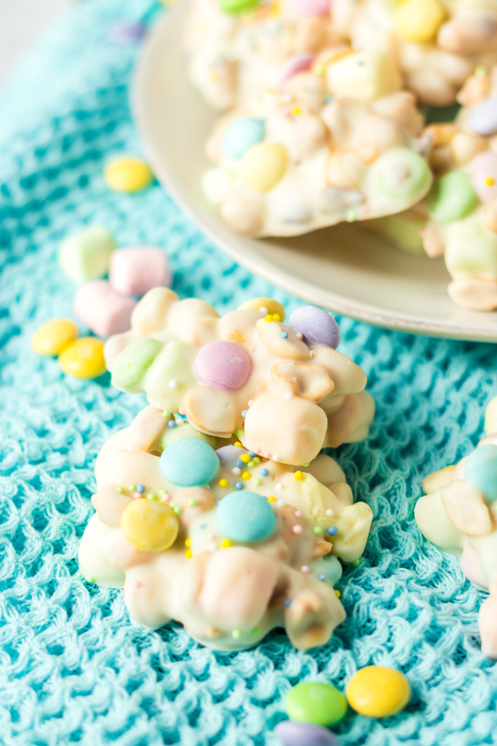 Two pieces of slow cooker Easter candy stacked on a teal linen.