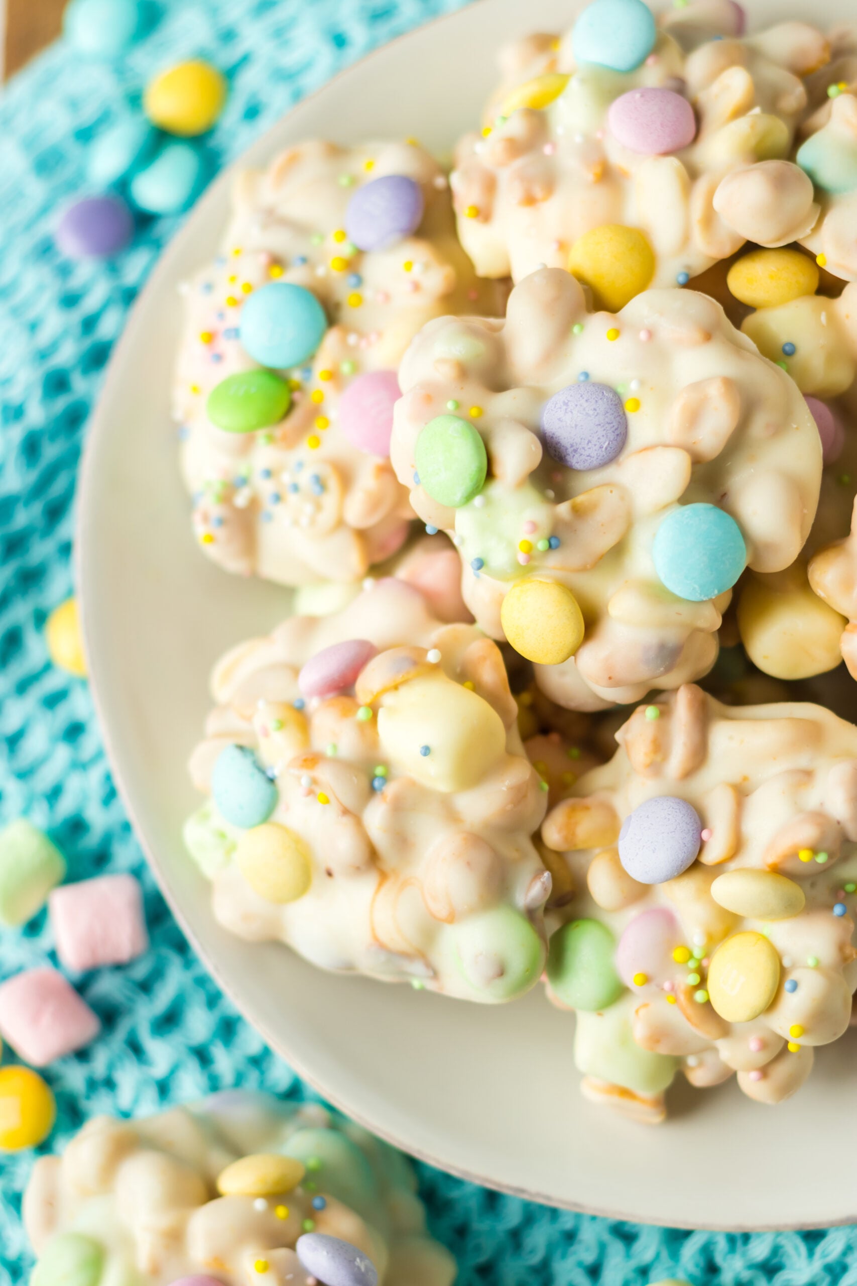Slow Cooker Easter Candy on a white plate with a teal linen in the background