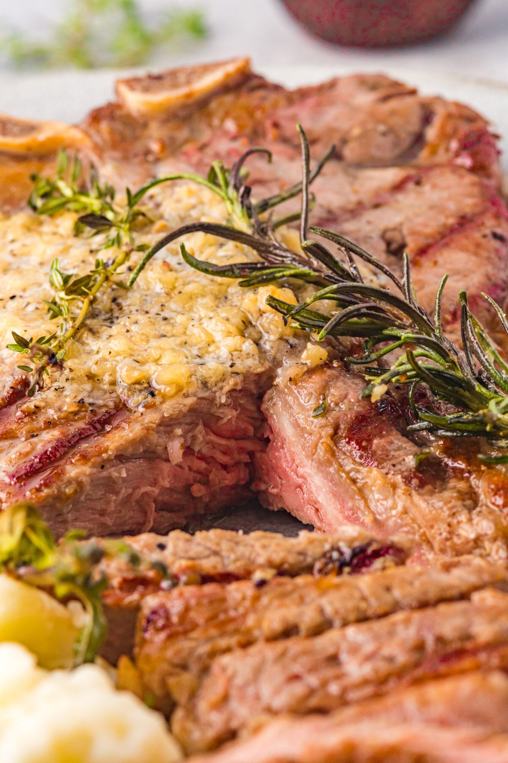Close up view of T Bone Steak with a bite removed.