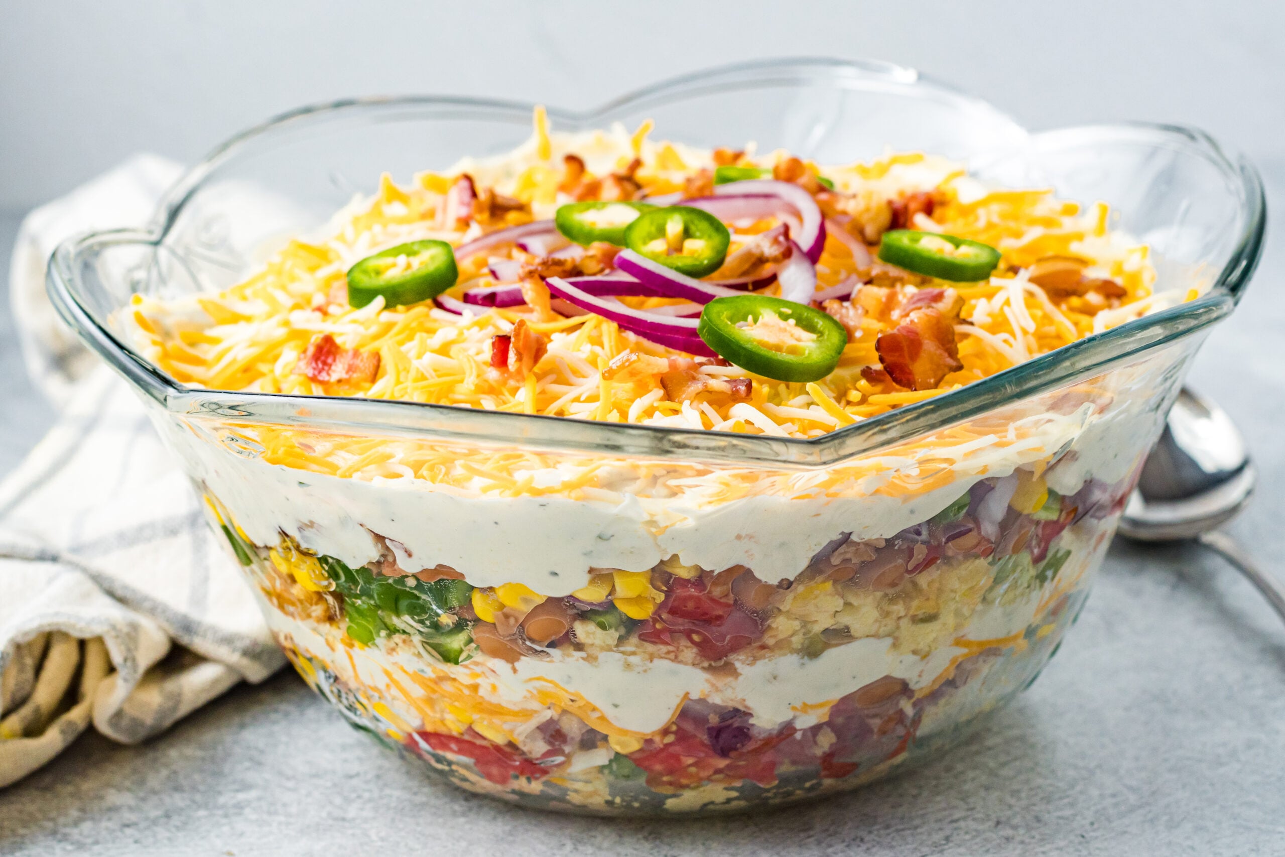 Cornbread Salad in a clear large bowl showing the layers.