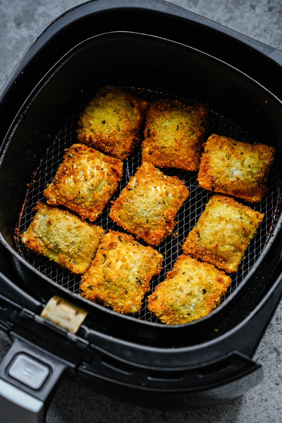 Air Fryer Ravioli in the air fryer basket.