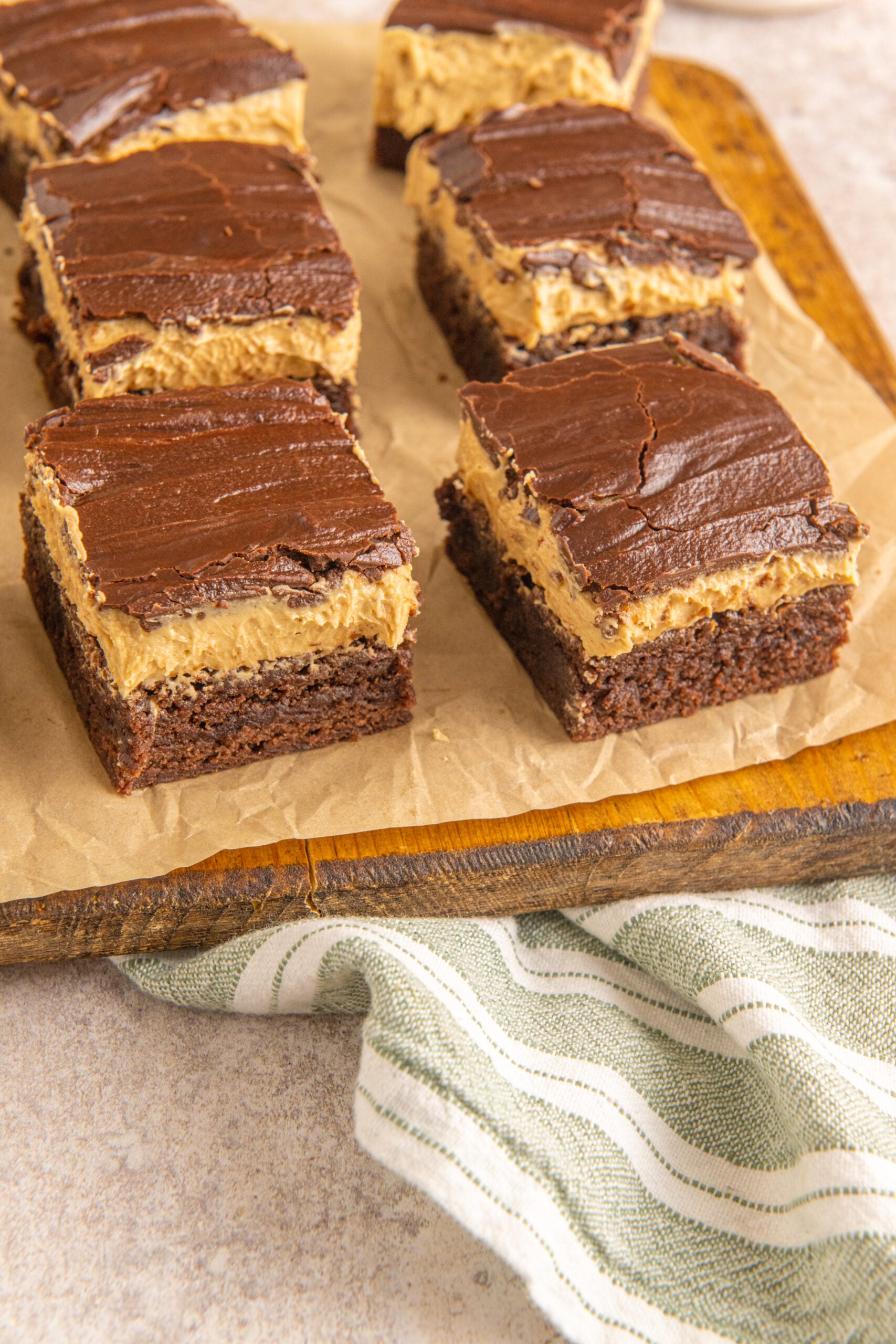 Side view of Buckeye Brownies on a wooden serving board. 