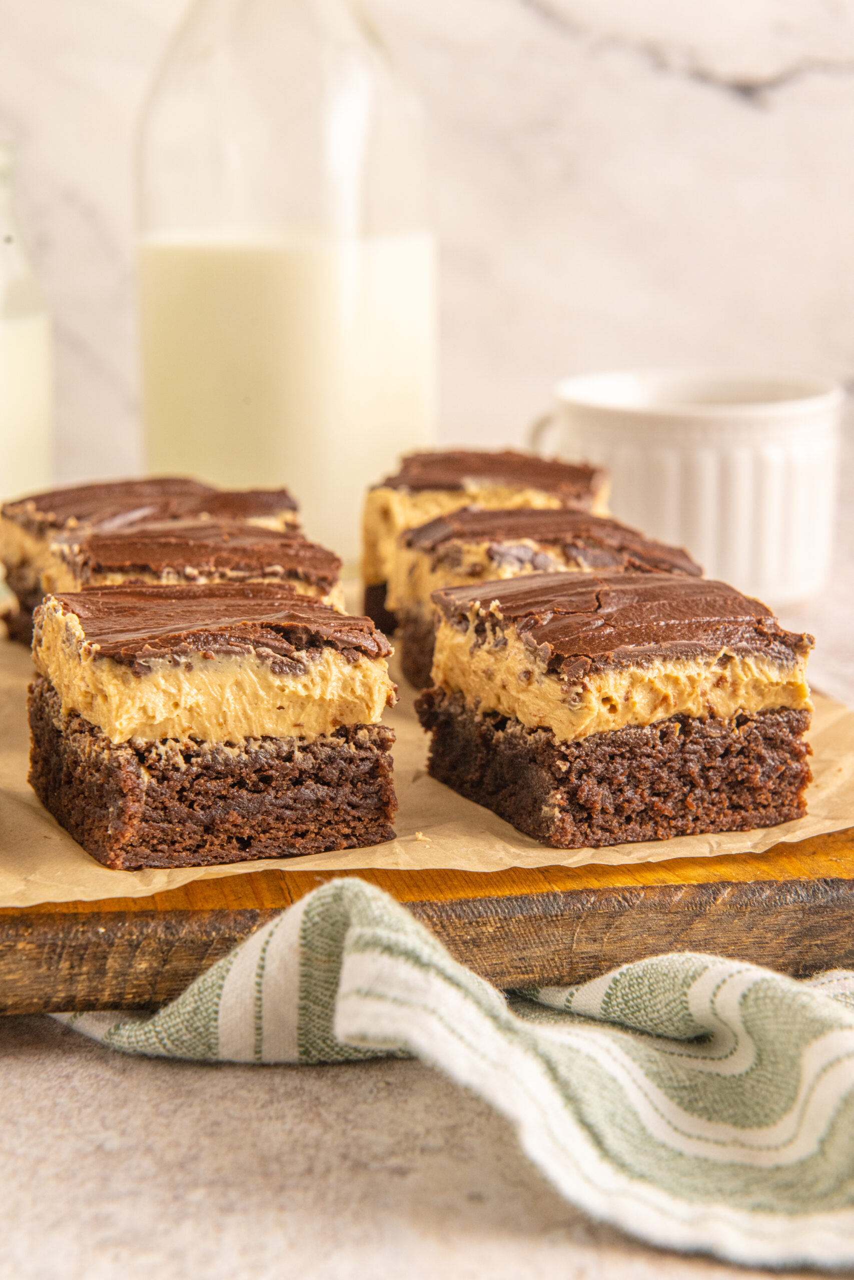 Side view of Buckeye Brownies on a wooden serving board. 