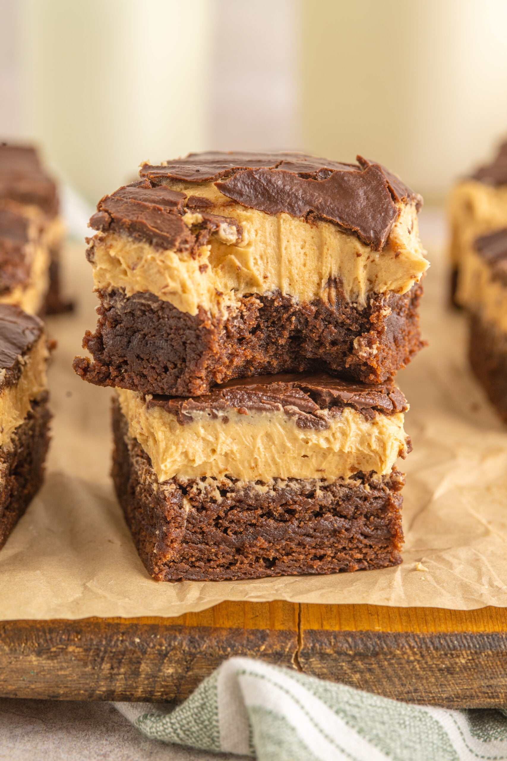 Two Buckeye Brownies stacked on top of each other with a bite removed from the top one. 