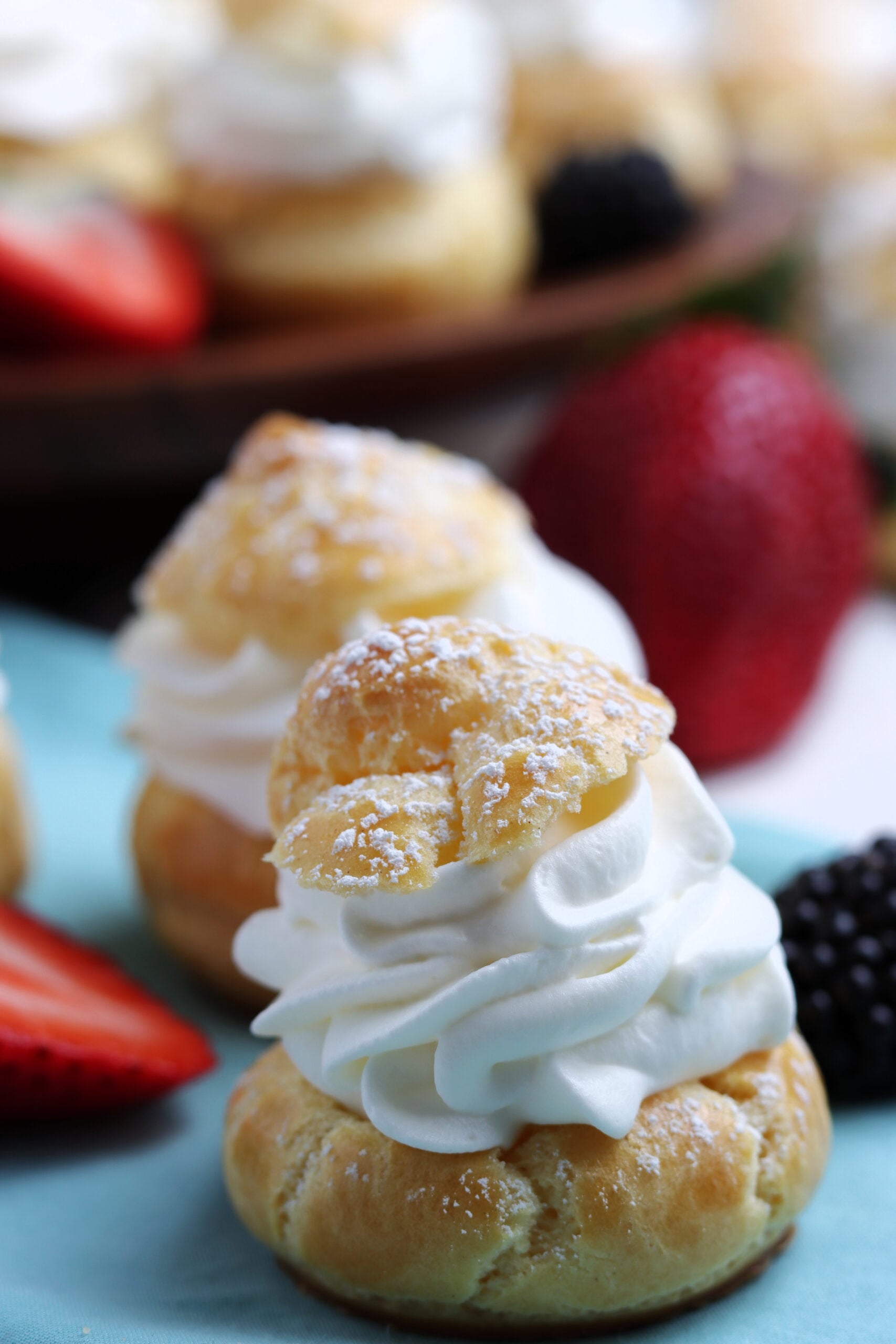 Close up shot of a cream puff sprinkled with powdered sugar. 