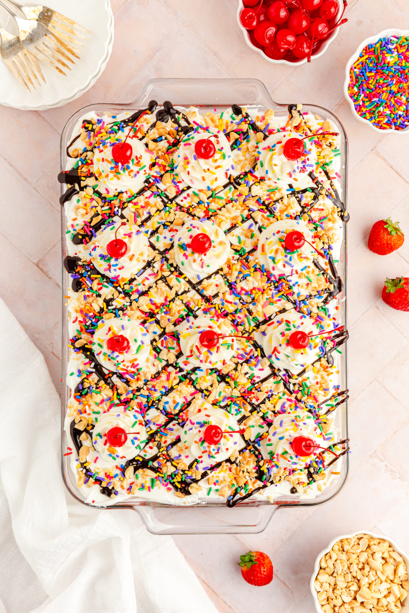 Overhead view of No Bake Banana Split Cake in a clear baking dish.