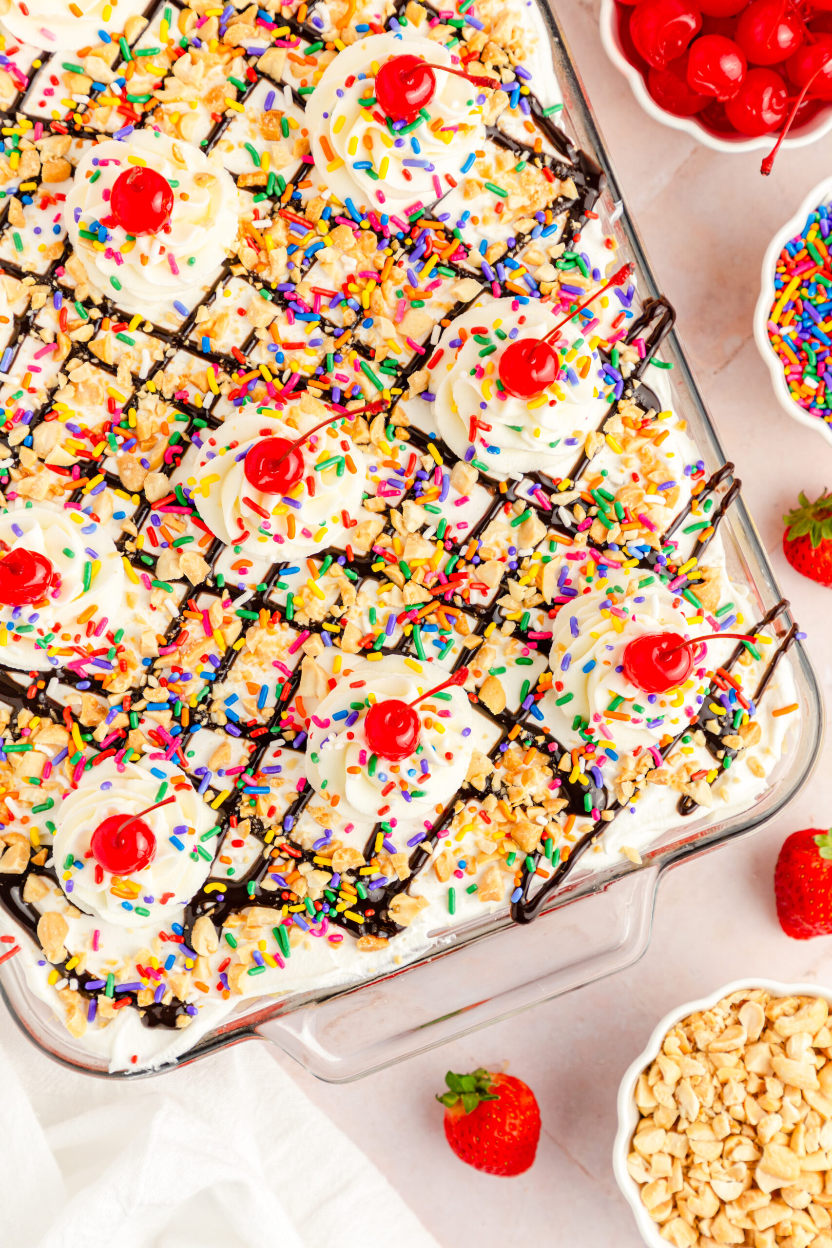 Overhead view of No Bake Banana Split Cake in a clear baking dish.